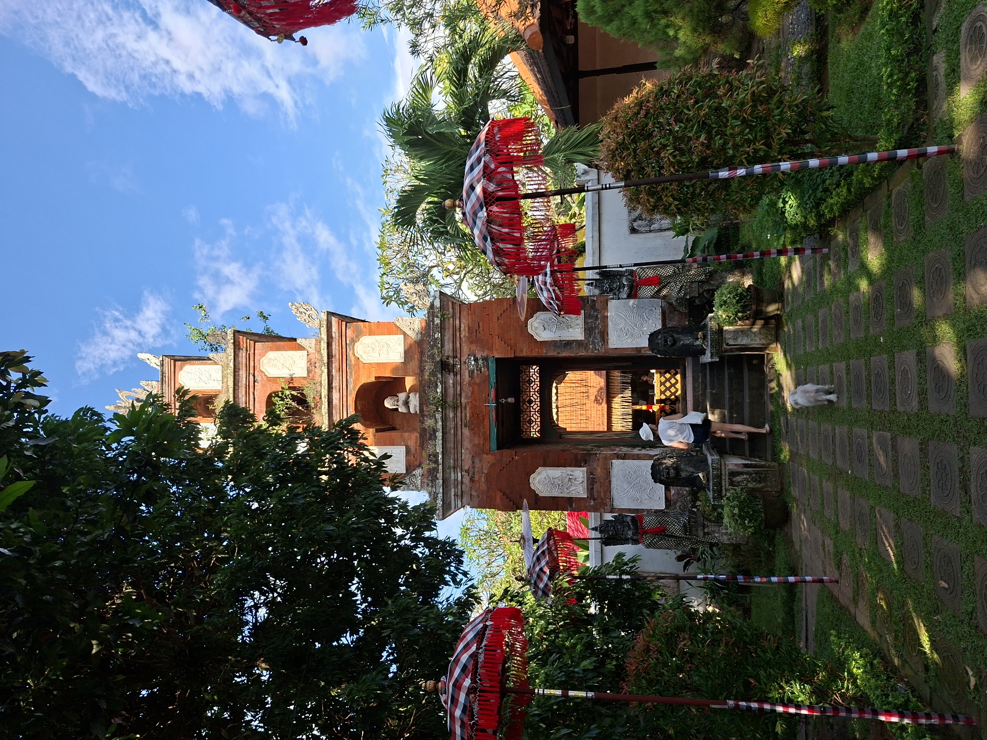 Traditional umbrellas frame historic water palace entrance in Karangasem