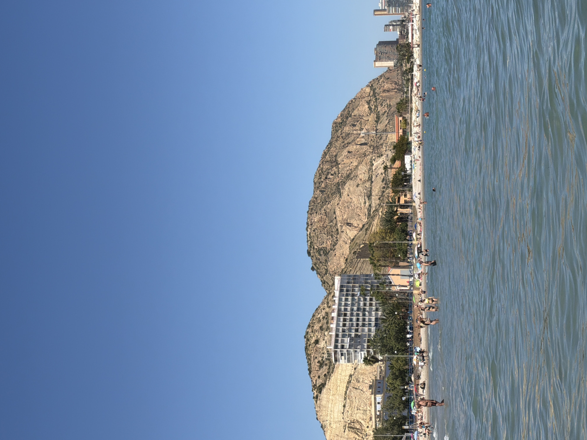 Beachgoers enjoy afternoon activities at Alicante's Playa del Postiguet