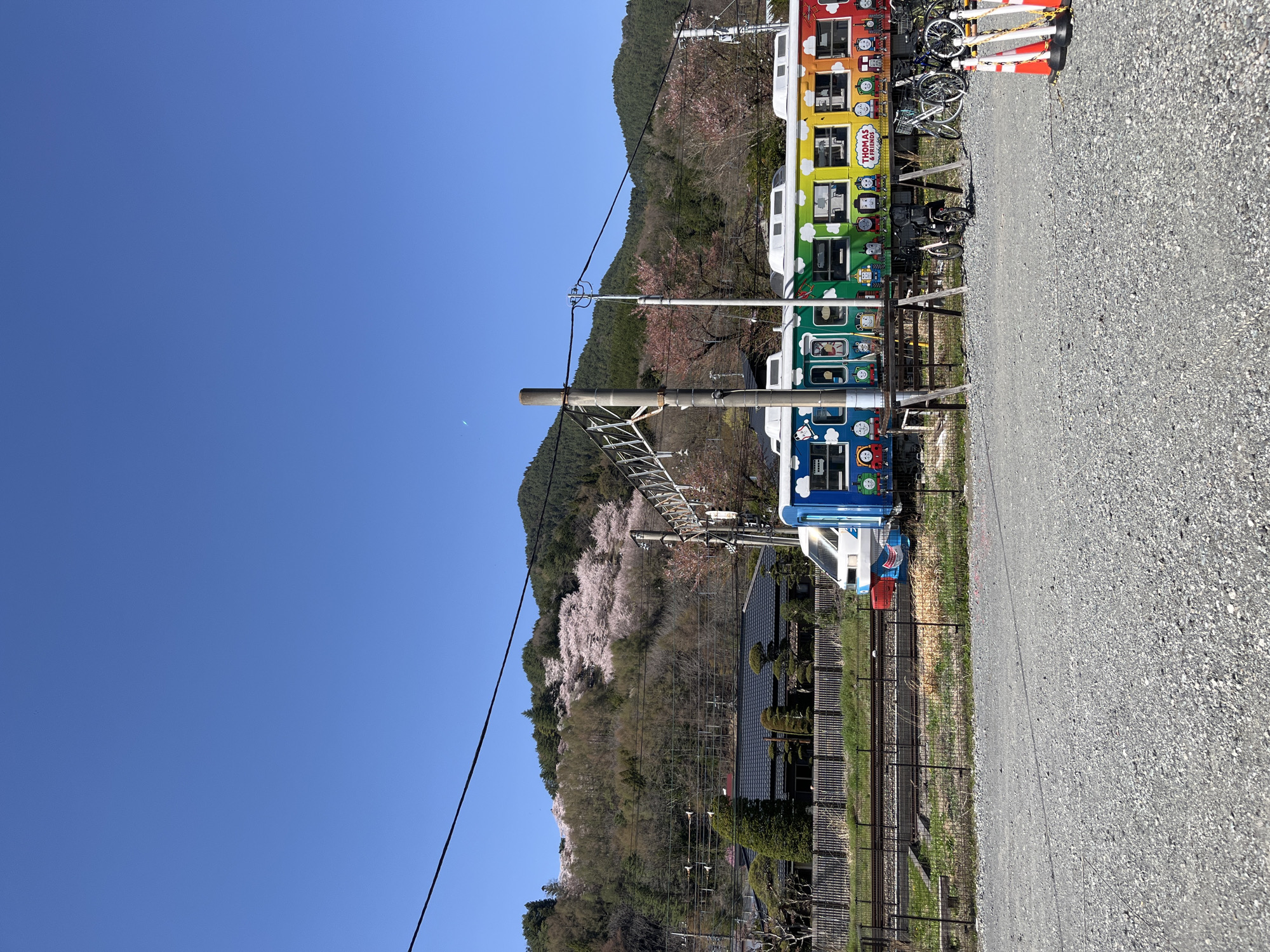 Rainbow character train spotted in Fujiyoshida with mountain backdrop