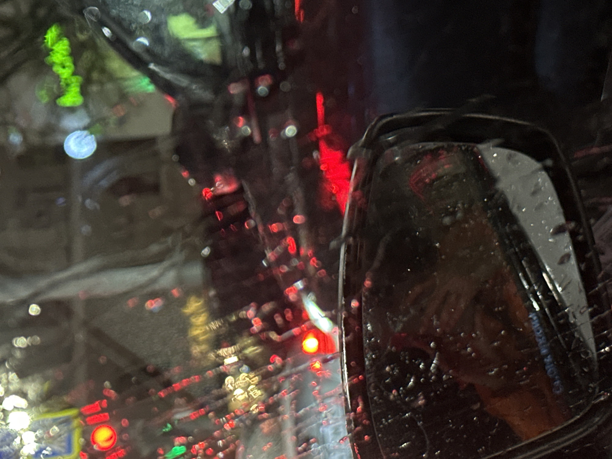 Rainy evening traffic captured through windshield in Ovoshchnoy, Russia