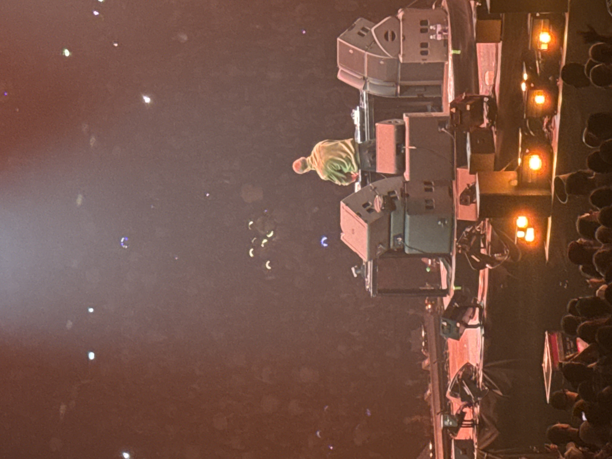 Concert performer in lime green hoodie spotted on Paris stage