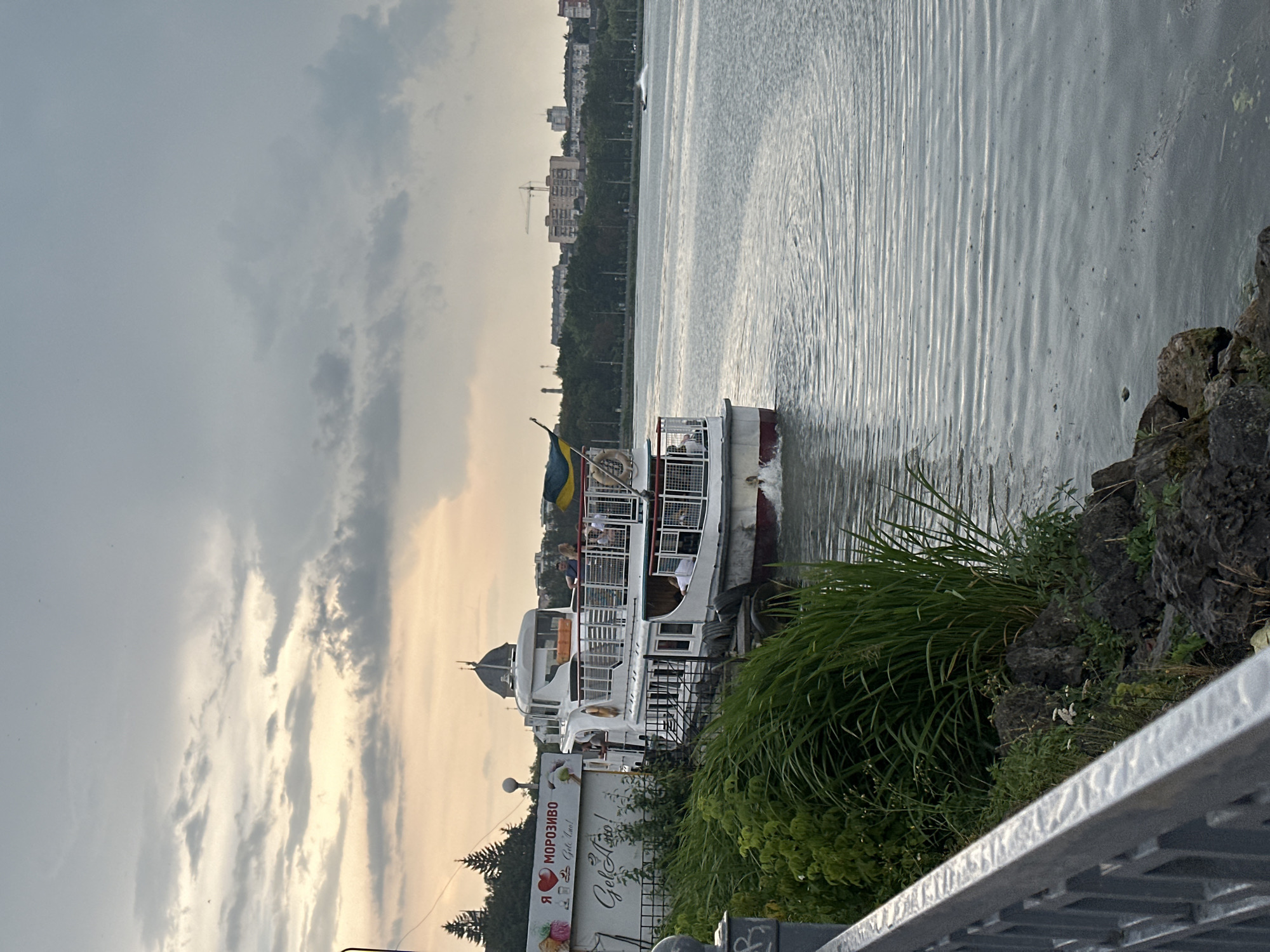Afternoon activity on Ternopil Lake — watercraft, boats, and waterfront steps