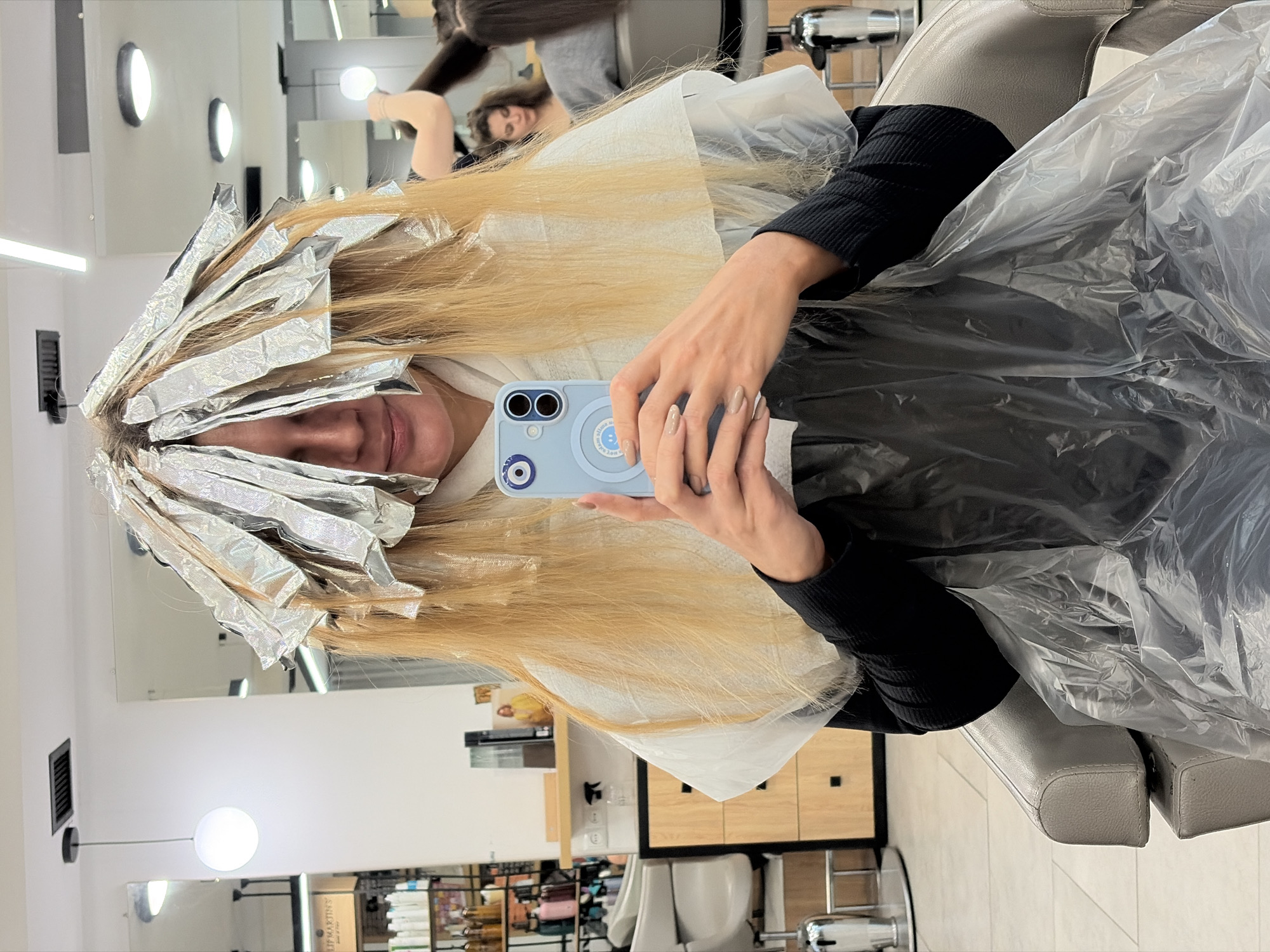Woman gets hair highlighted at Tbilisi salon