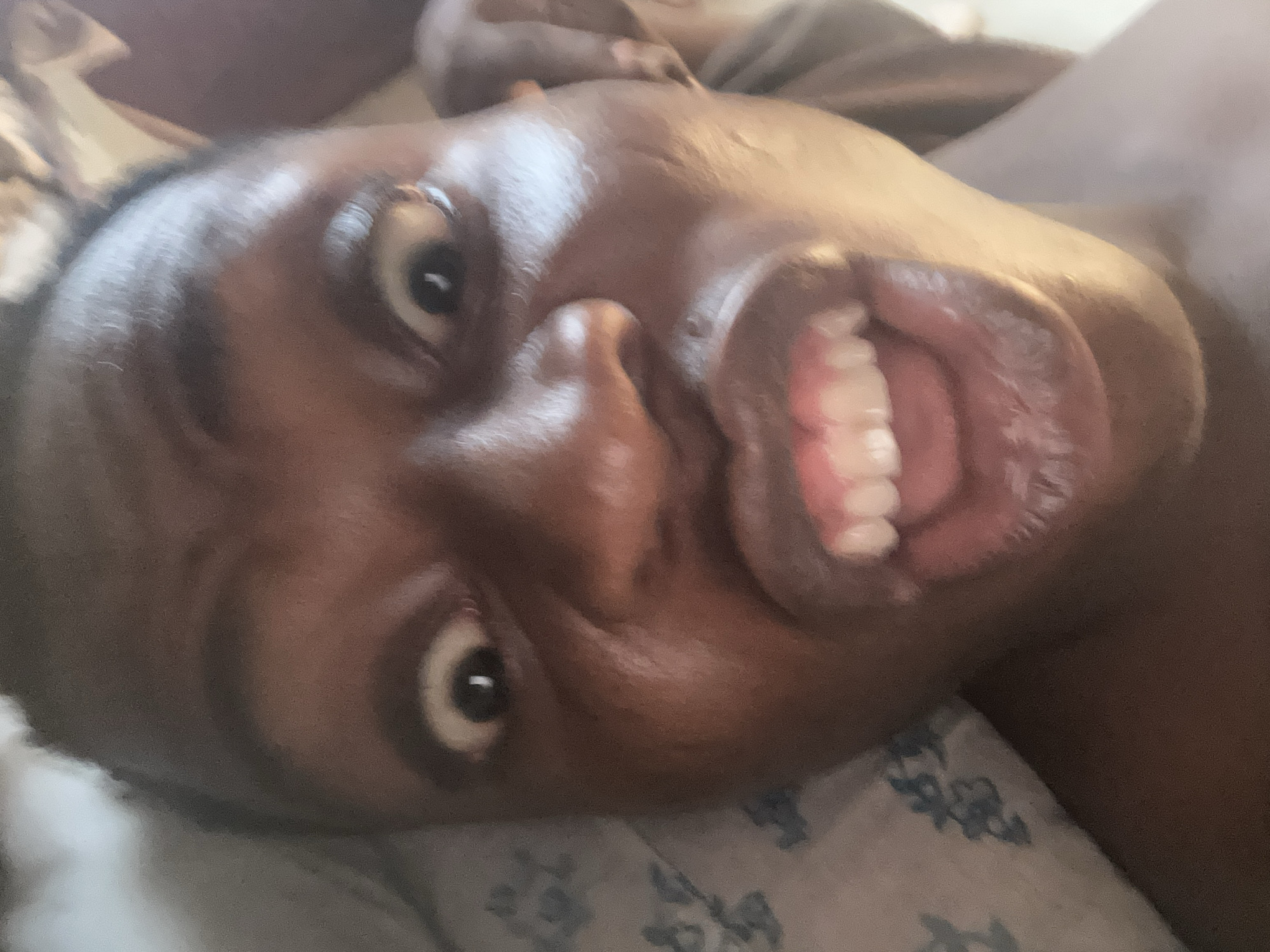 Person photographed in various expressions while resting on bed