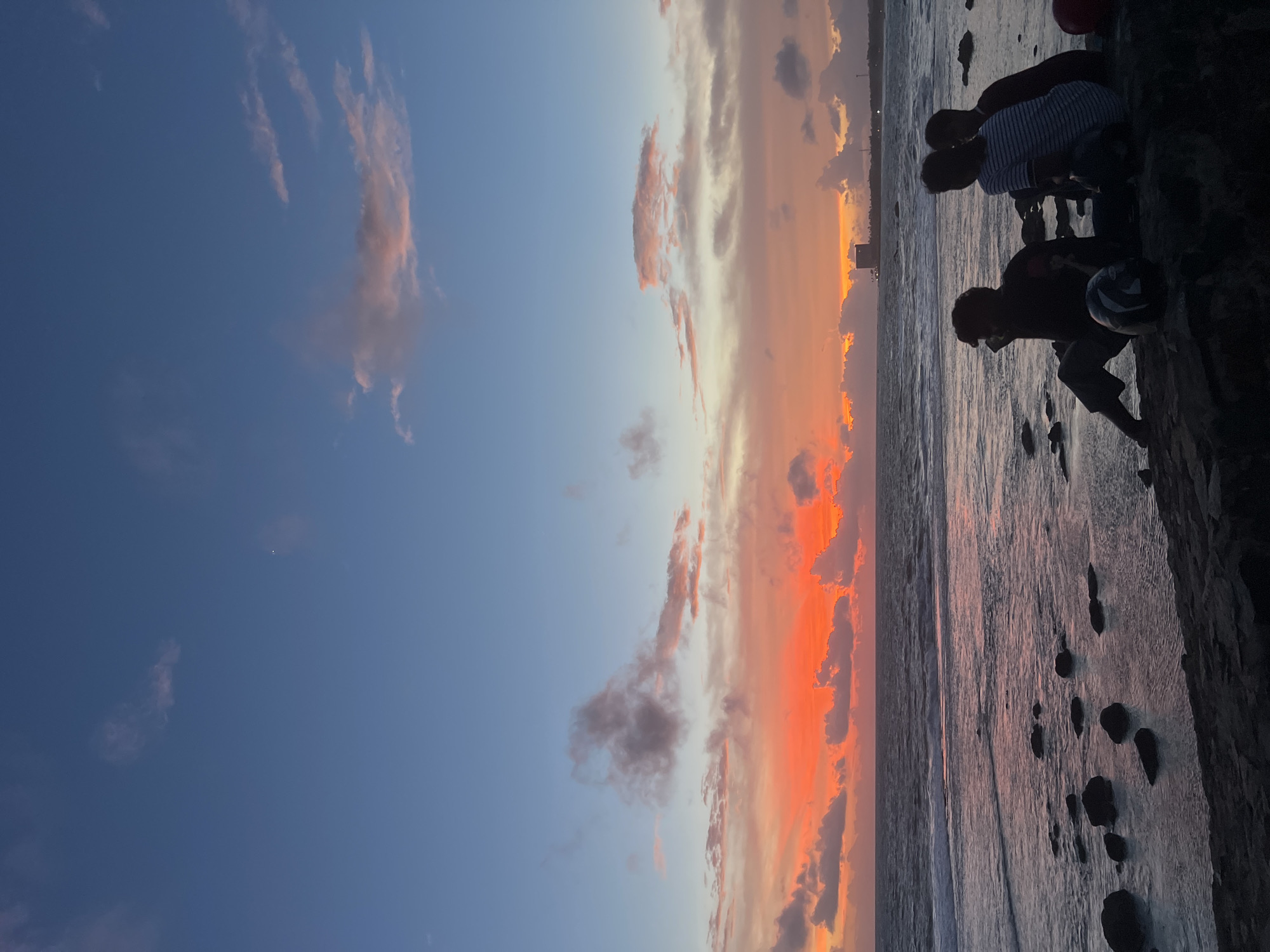 Sunset crowd gathers along Galle Fort's rocky coastline