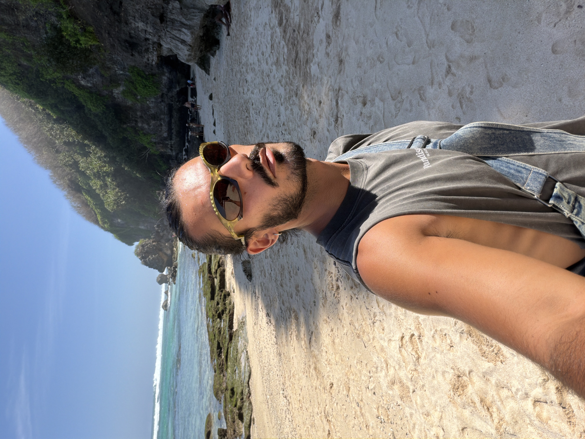 Busy beach morning along Kuta Selatan's rocky coastline