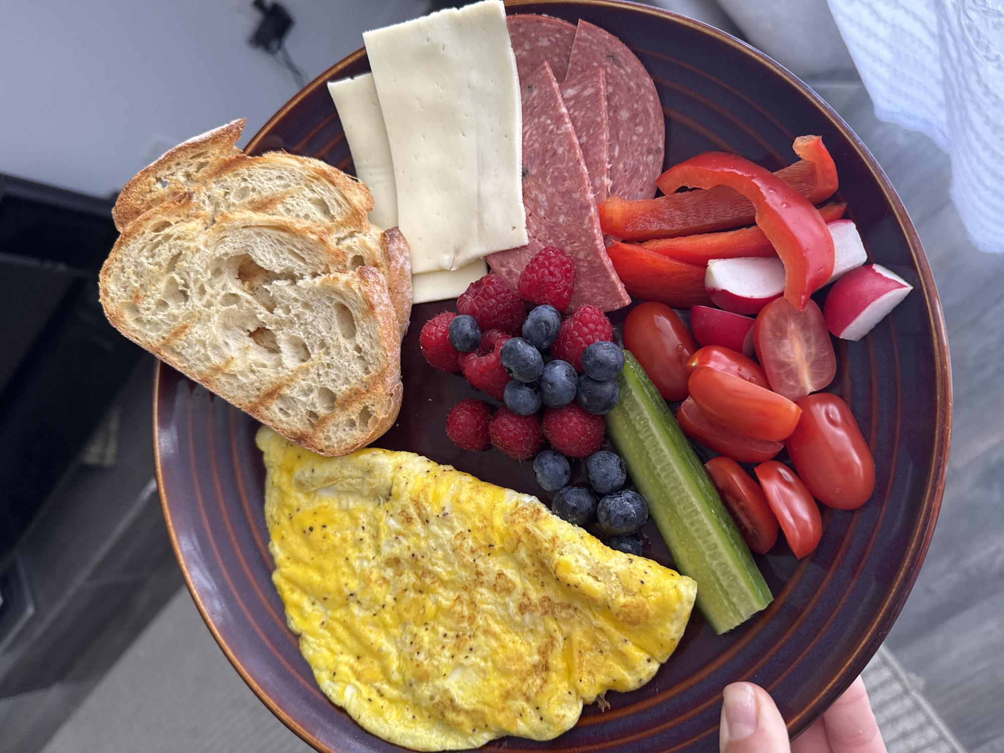 Person prepares omelet breakfast with fresh coffee in Gatineau