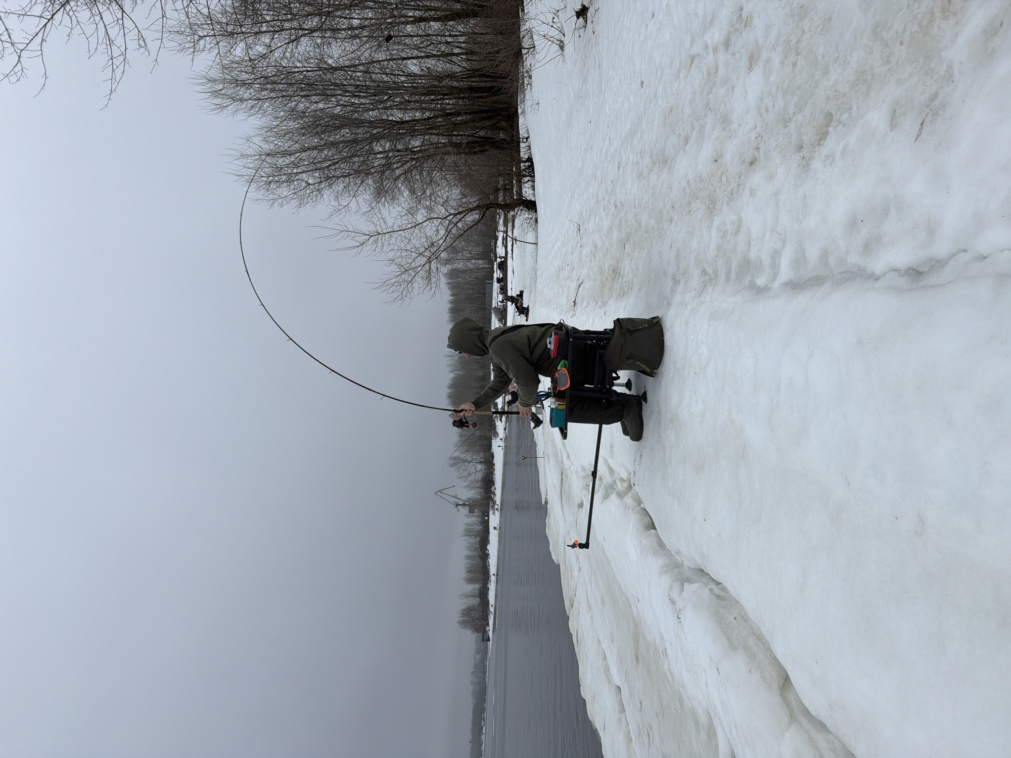 Ice fisherman catches small fish in early morning Chaikovsky session