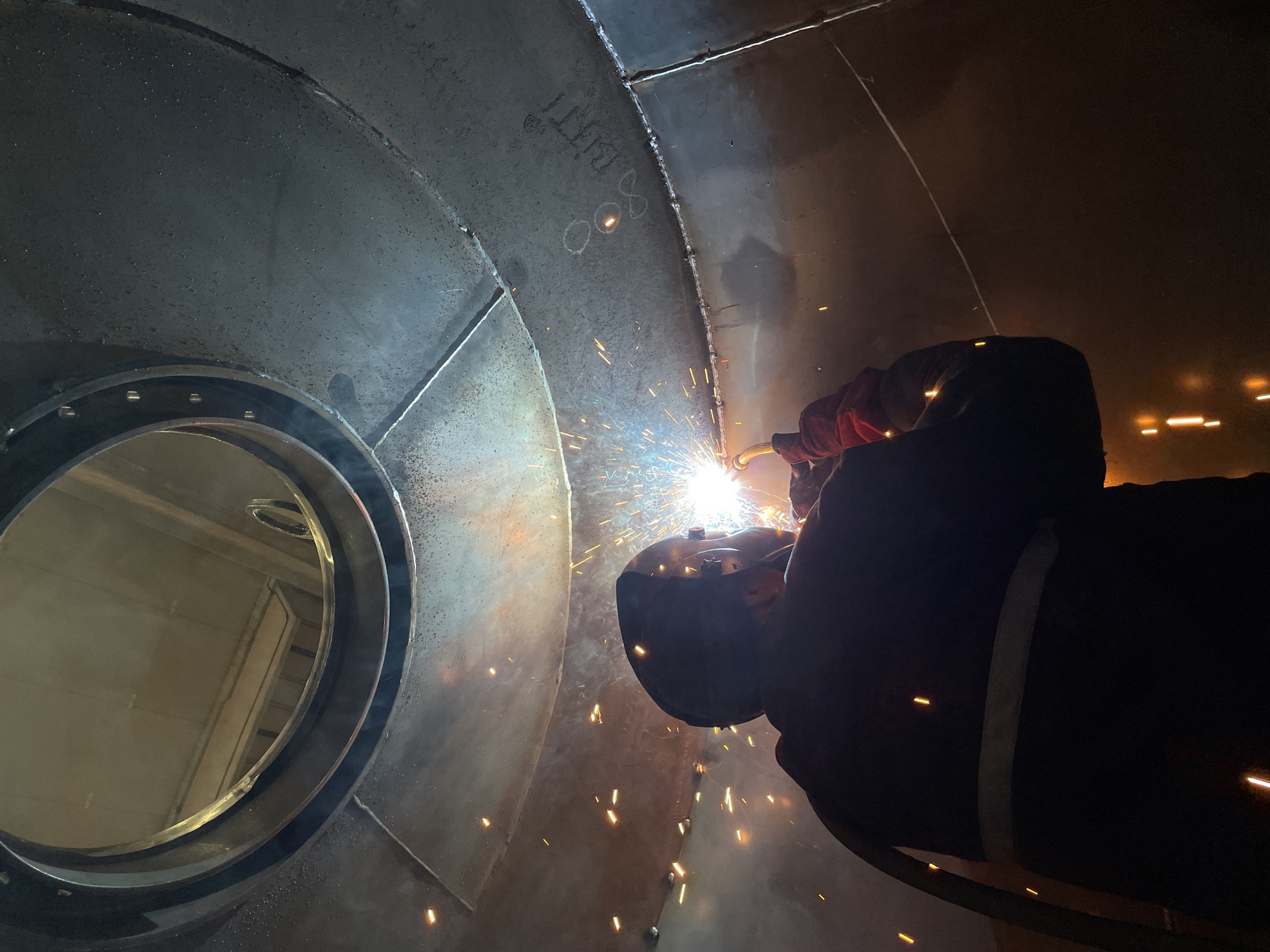 Welder performs industrial work inside metal structure in Montenegro