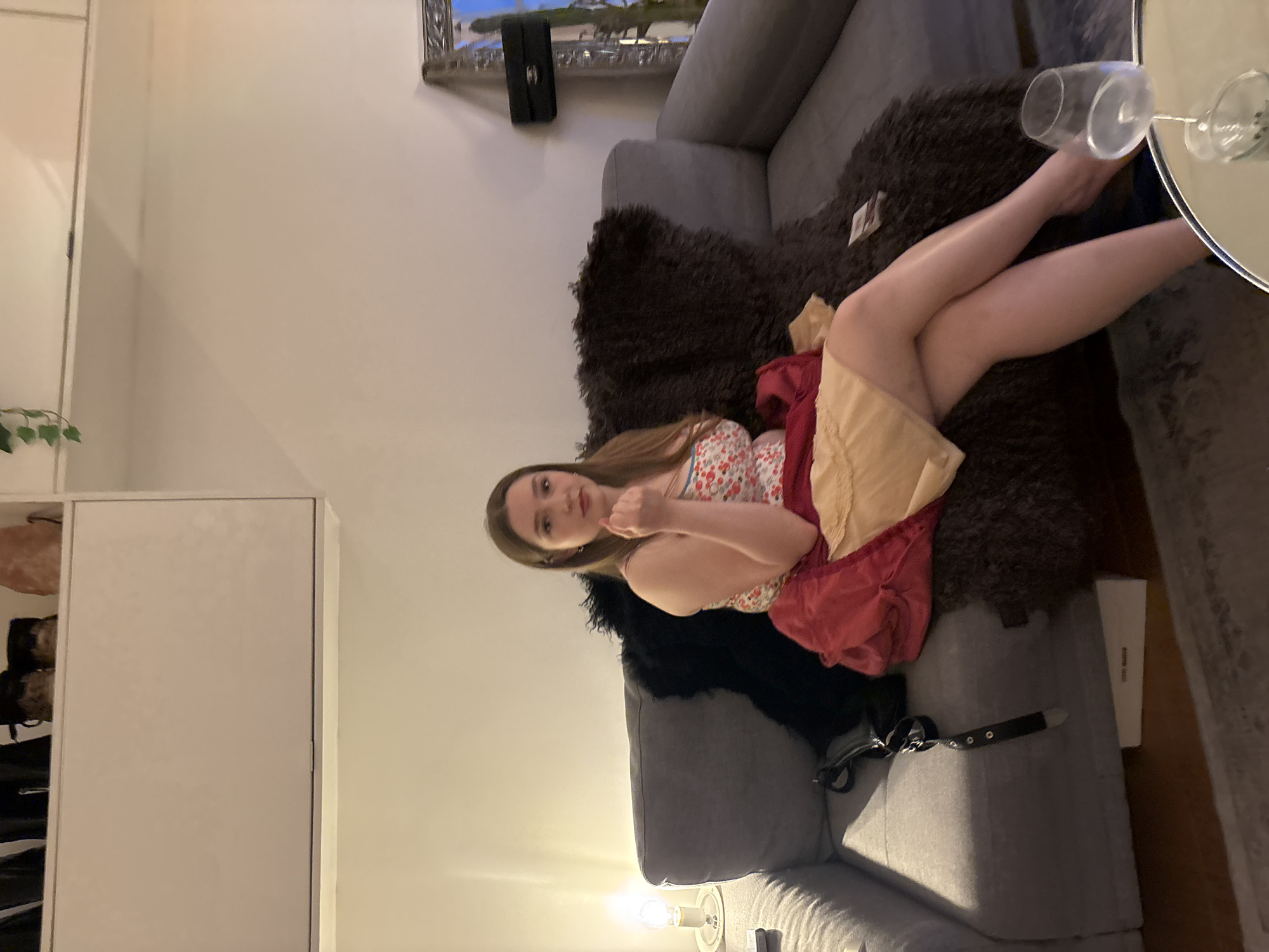 Woman relaxes in London living room during evening hours