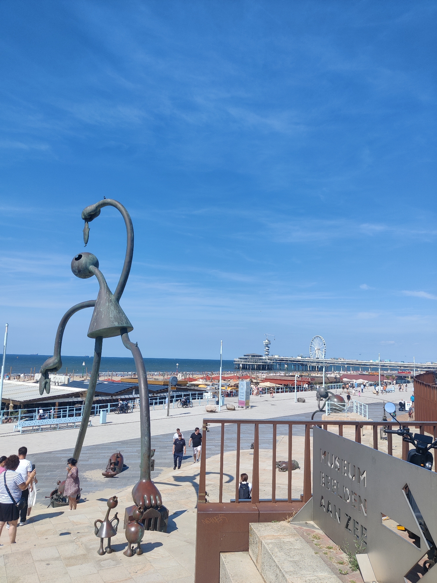 Scheveningen's sculpture-lined beachfront on a busy summer afternoon