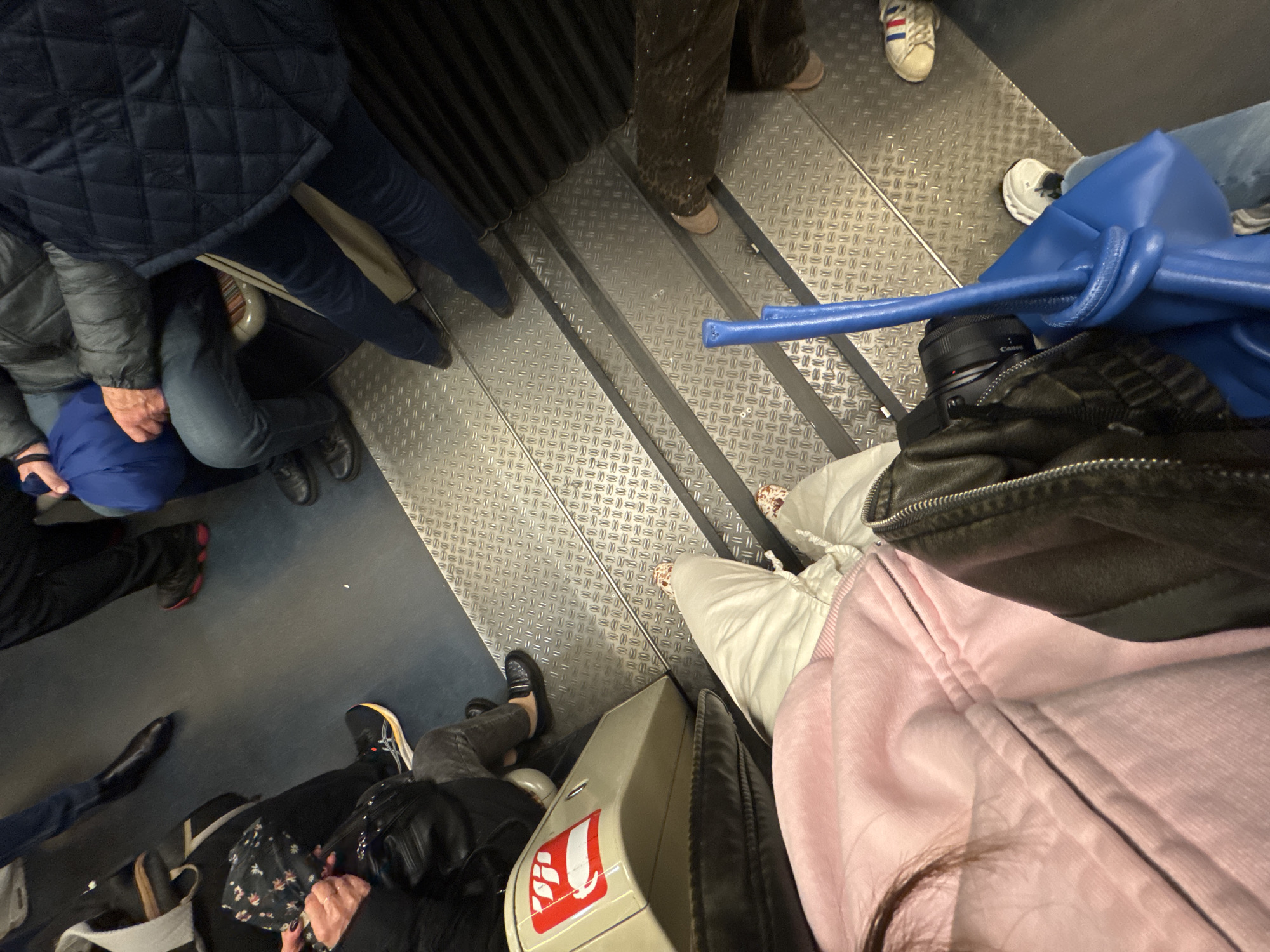 Passengers ride Paris metro during midday commute