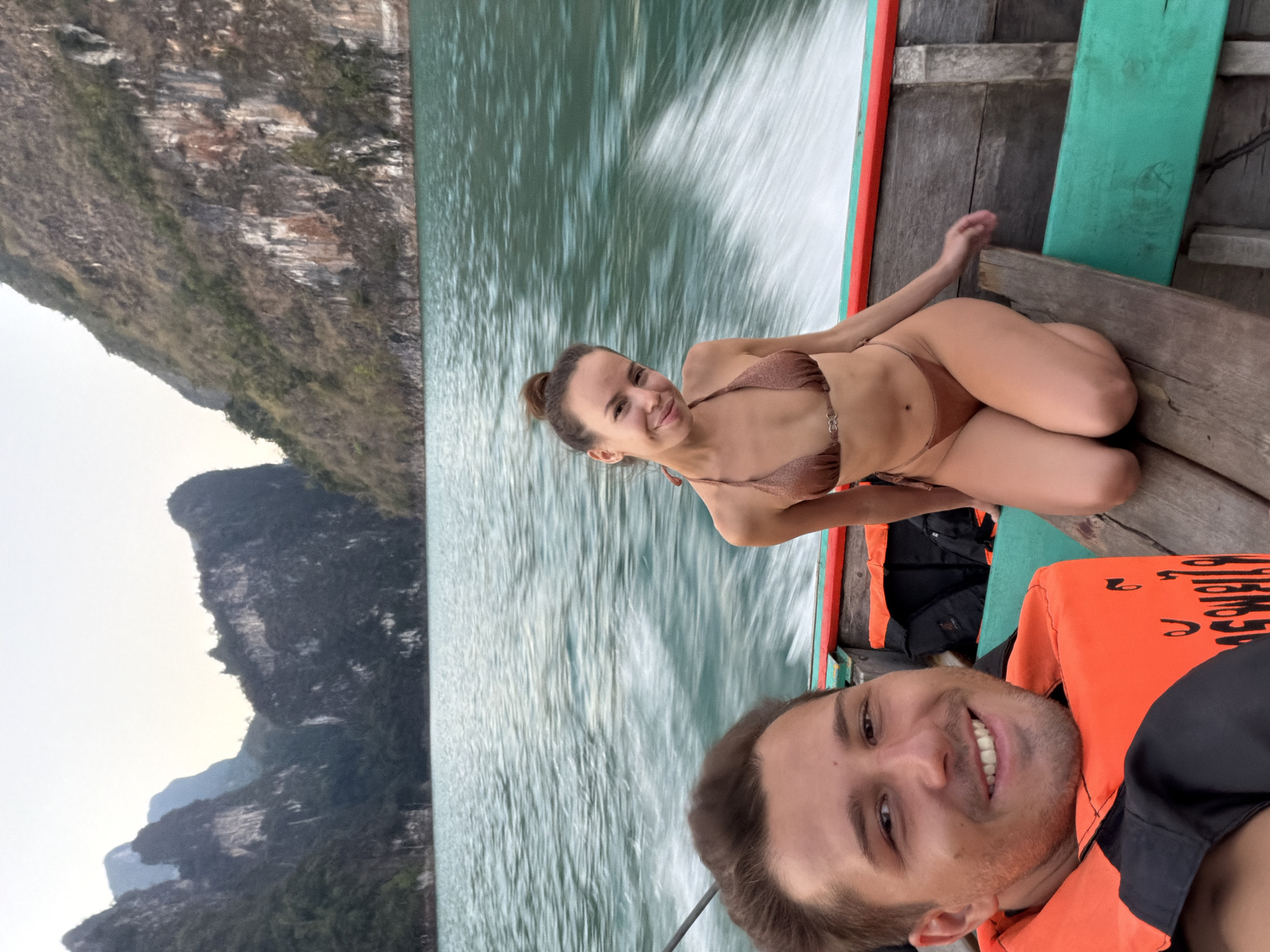 Tourists travel by longtail boat through Khao Phang waters