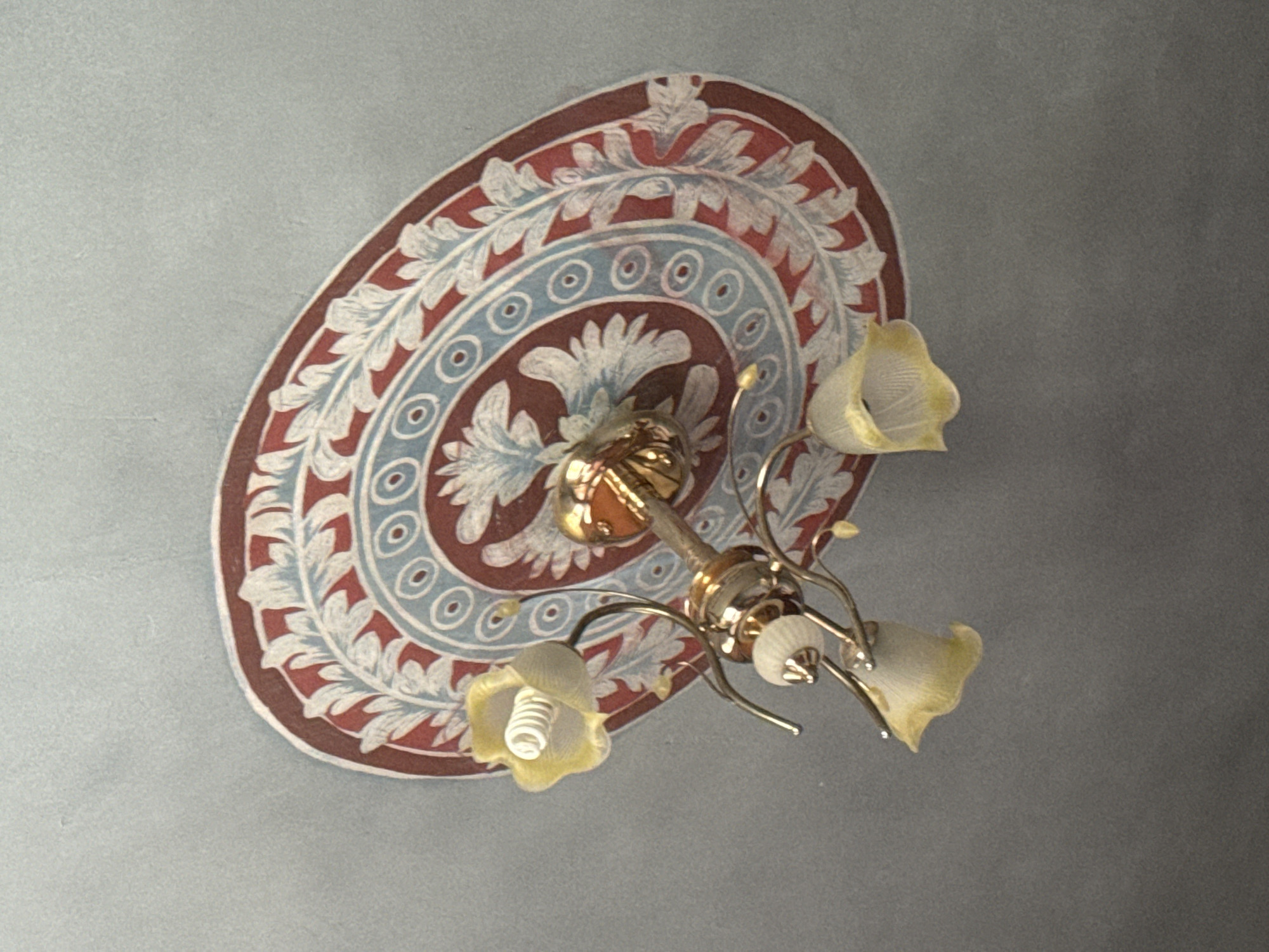 Ornate chandelier and ceiling fresco inside a Kosh, Armenia building