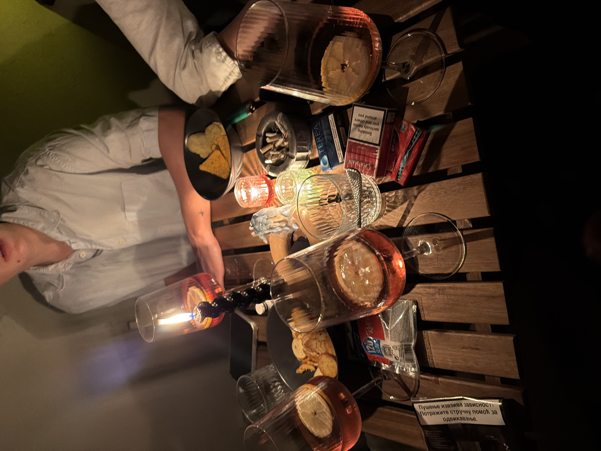 Friends gather for candlelit drinks on Belgrade balcony