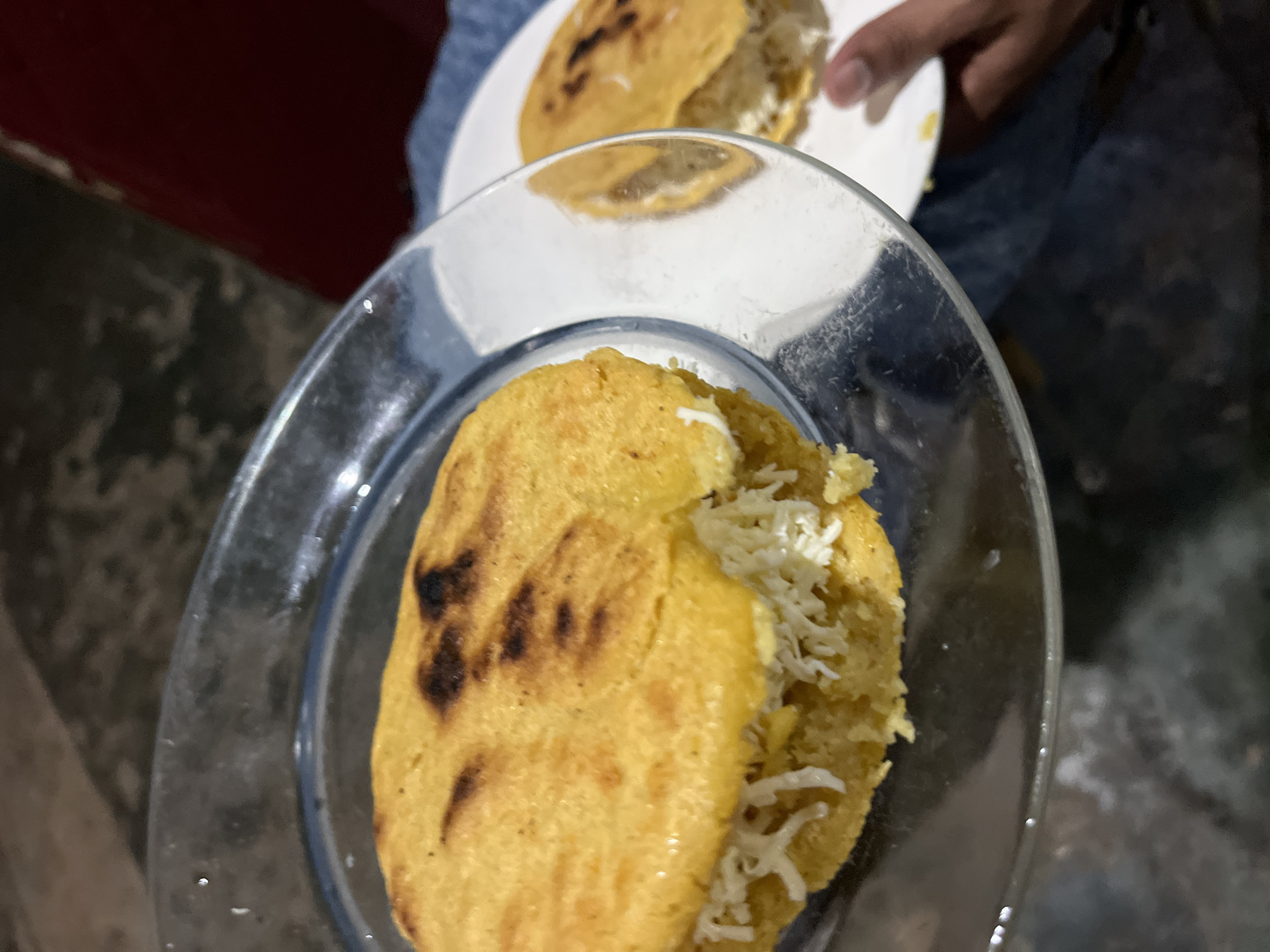 Arepas on the griddle, small dogs at home in Juan Griego
