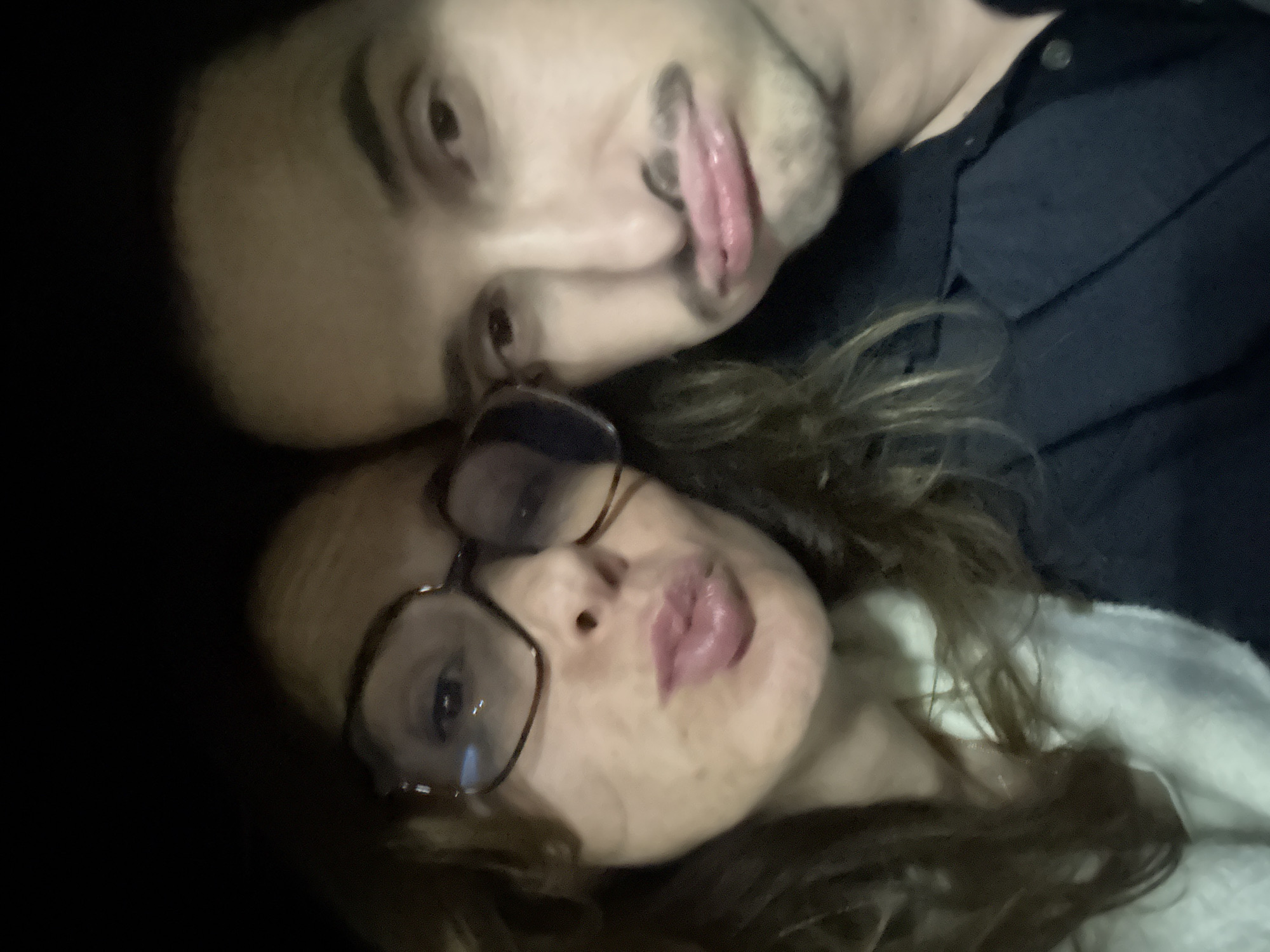 Two people take selfie in dimly lit Loures location