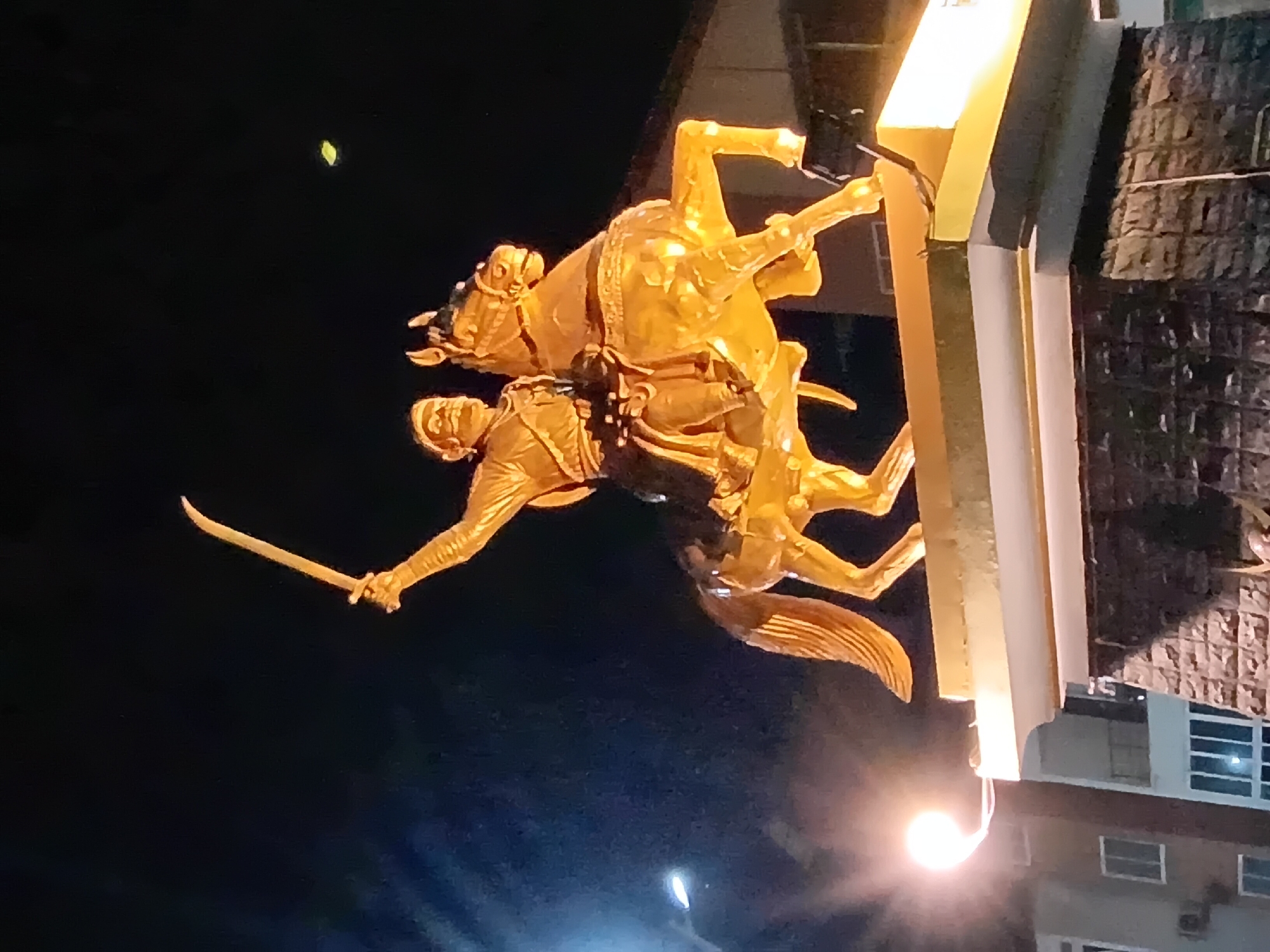 Golden warrior statue observed in Oxel roundabout during evening