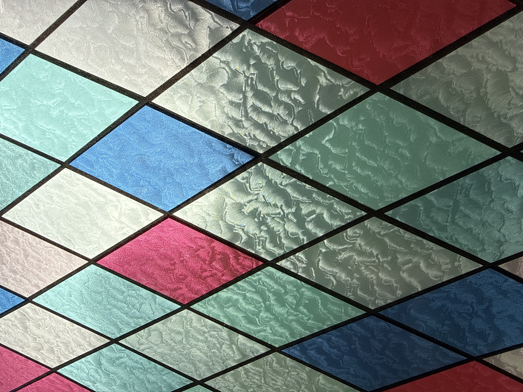 Colorful diamond-paned stained glass window observed in Sofia