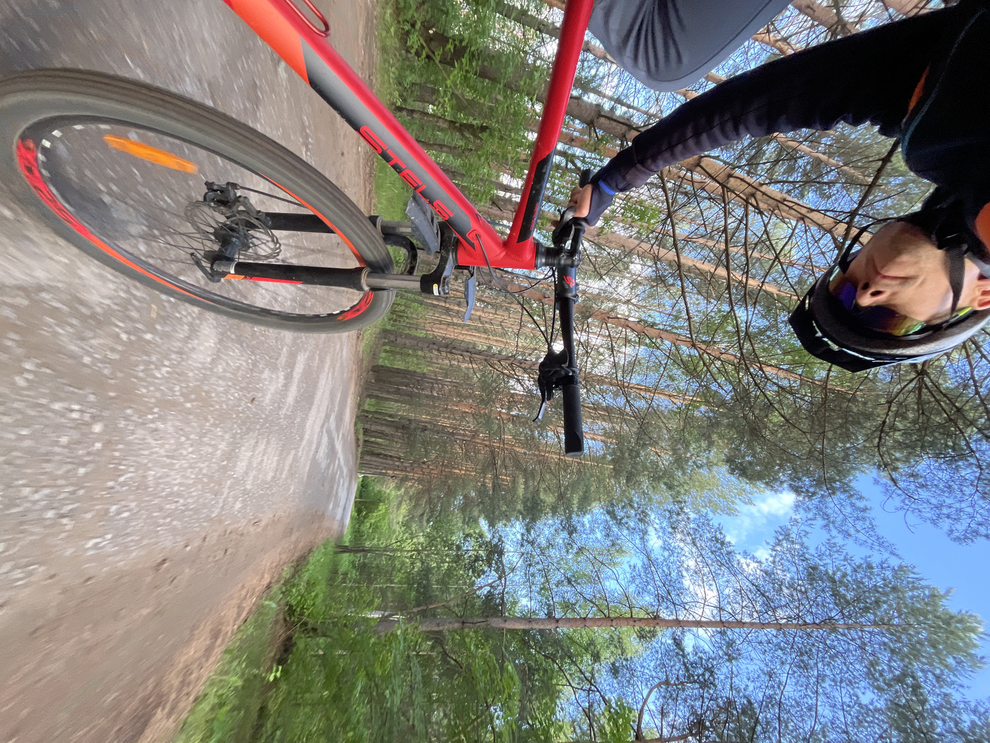 Woman enjoys biking and photography during sunny afternoon in Chaikovsky