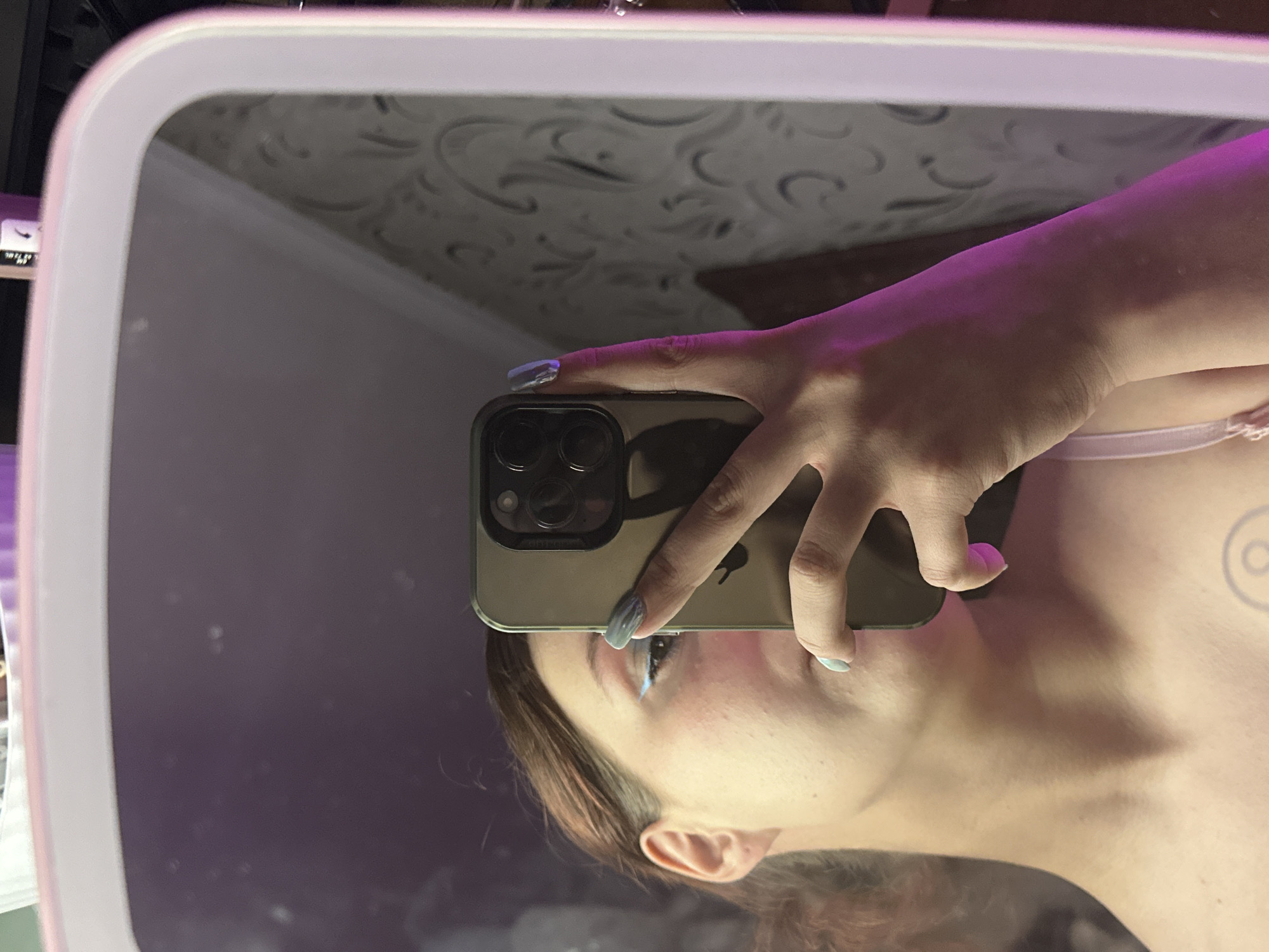 Purple-lit bedroom selfie session in Bishkek