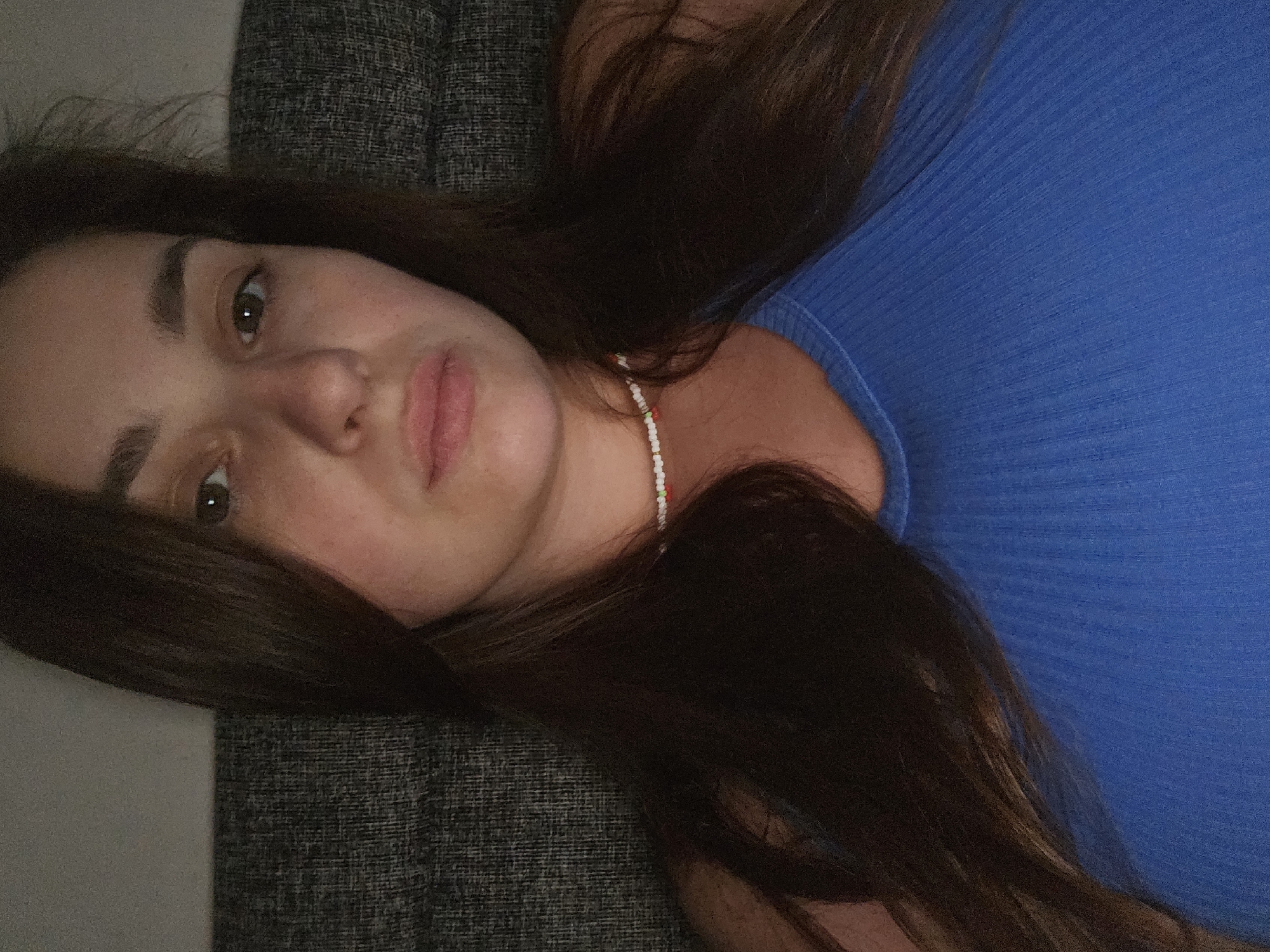 Indoor self-portrait session, blue top and cherry necklace, near Kyiv