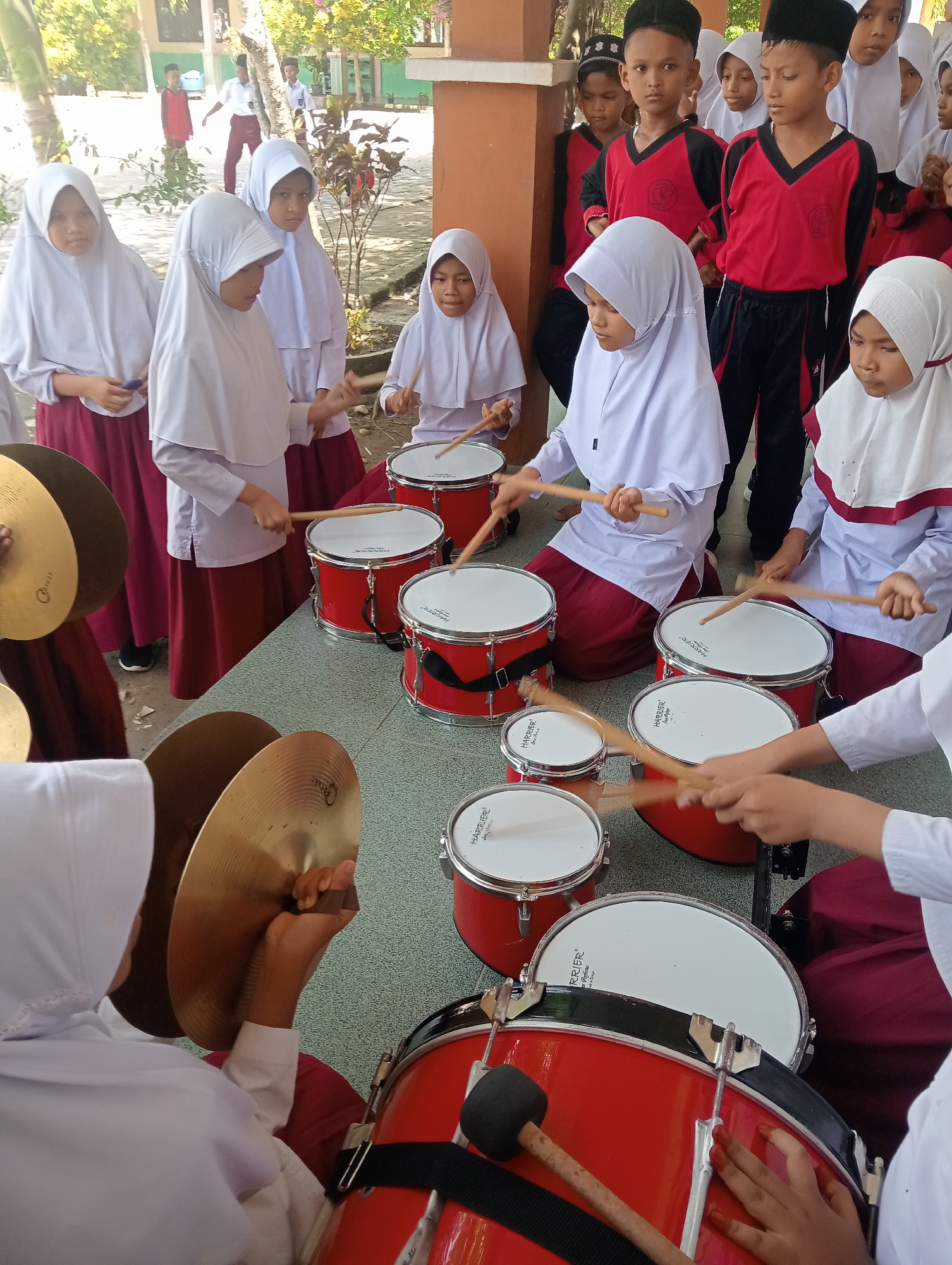 School drumline practice in a Baratpayaitek courtyard