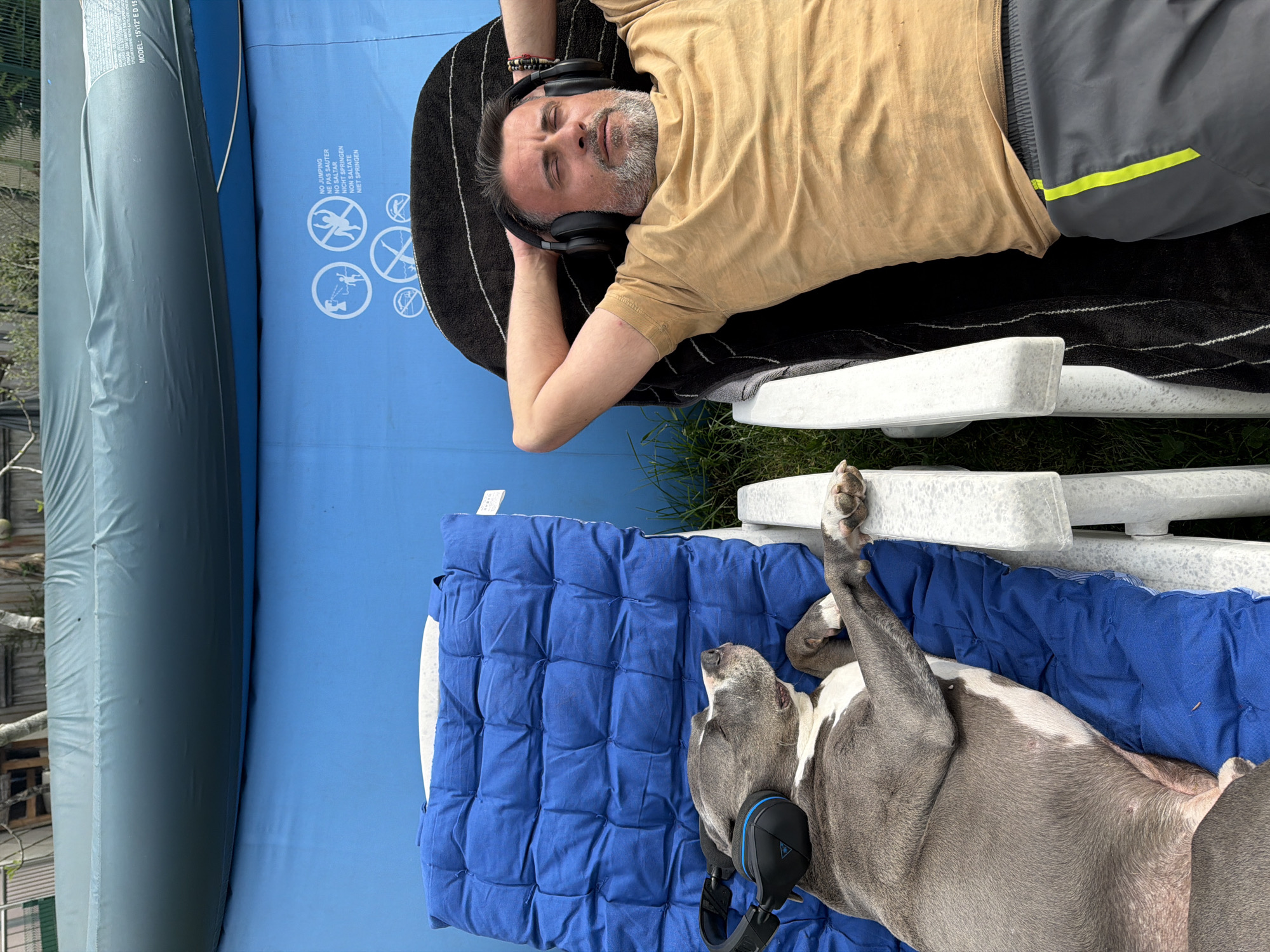 Man and dog share headphones during Sunday relaxation in Luxembourg