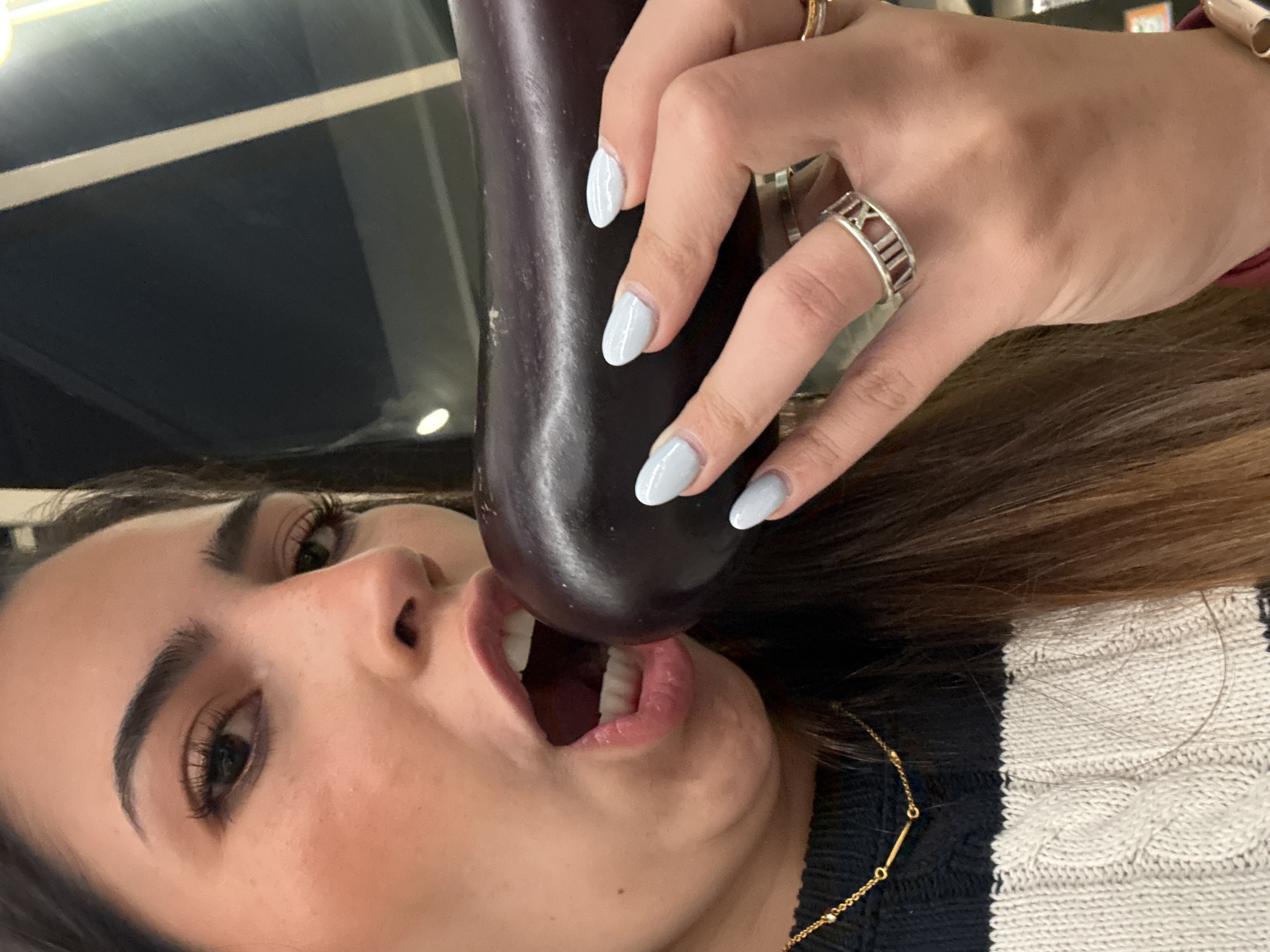 Woman playfully poses with produce during supermarket shopping in Puebla
