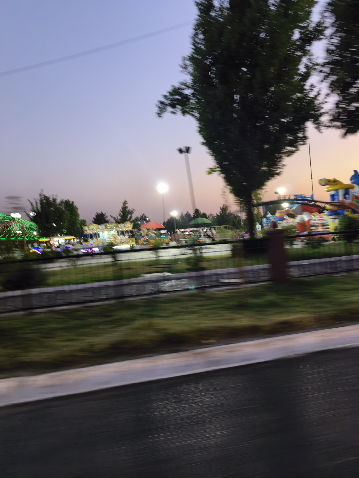 Dusk settles over a Fergana City amusement park