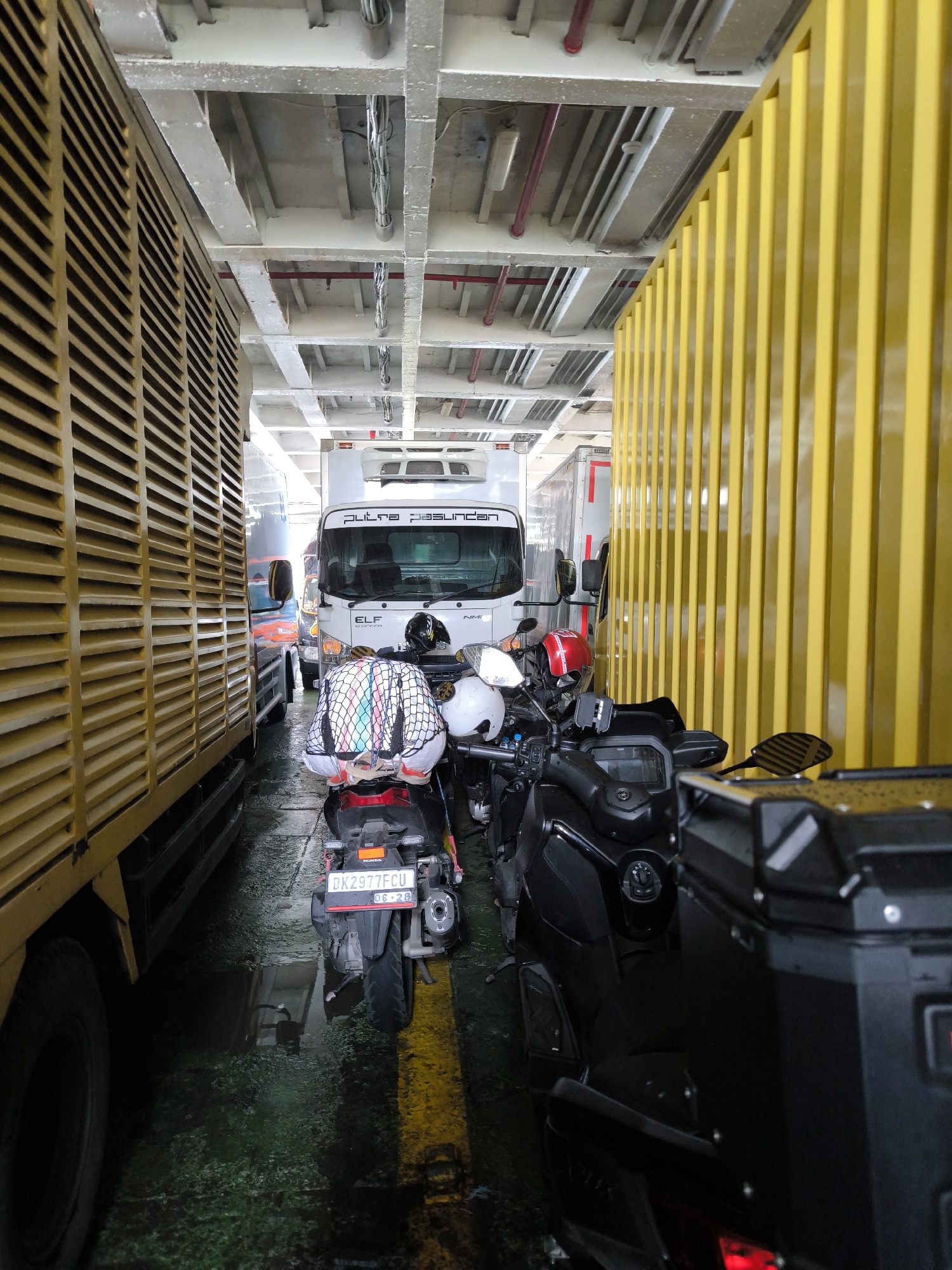 Vehicles packed on ferry deck captured in transit