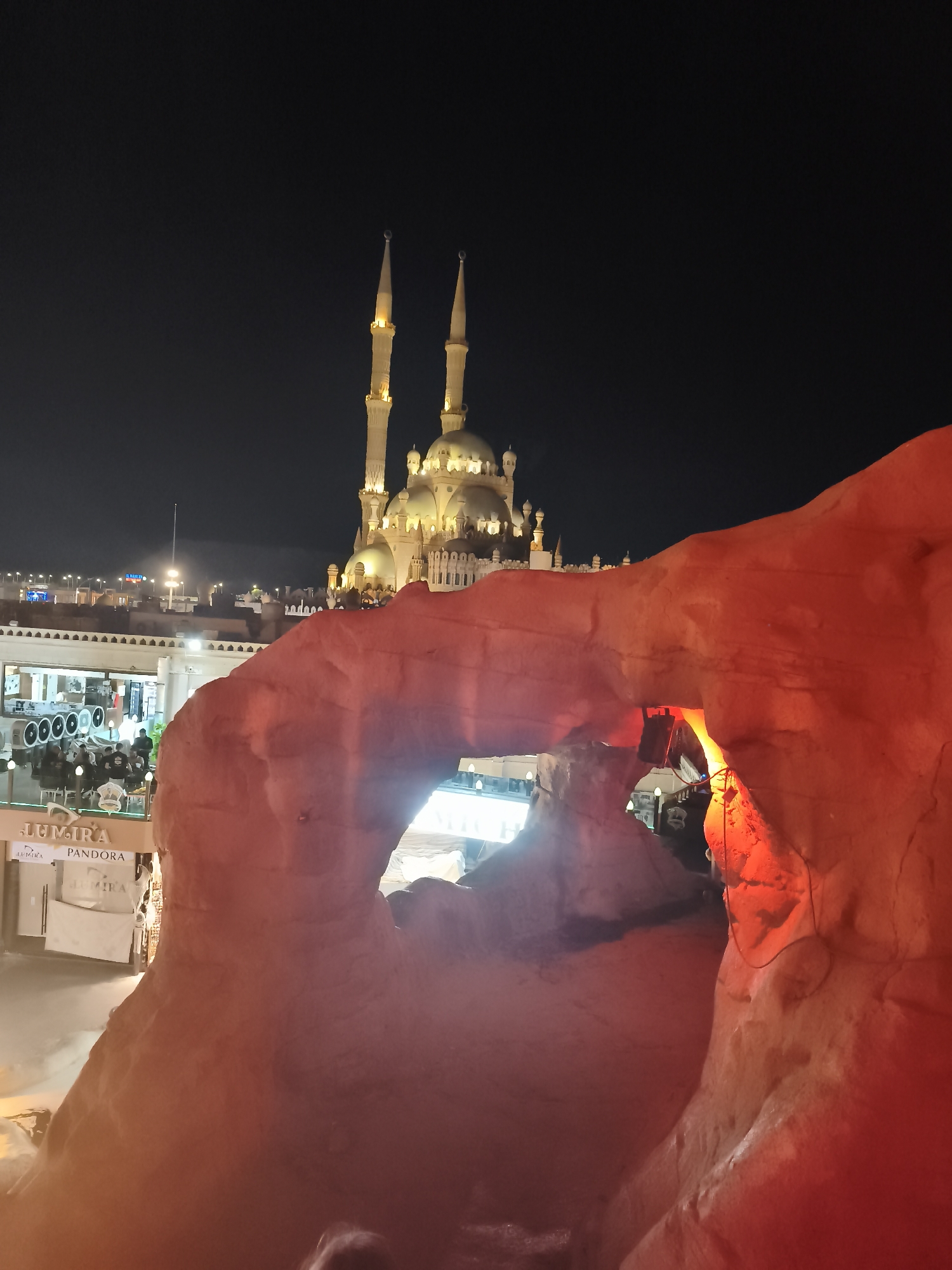 Naama Bay at night: mosque, markets, and cave venues