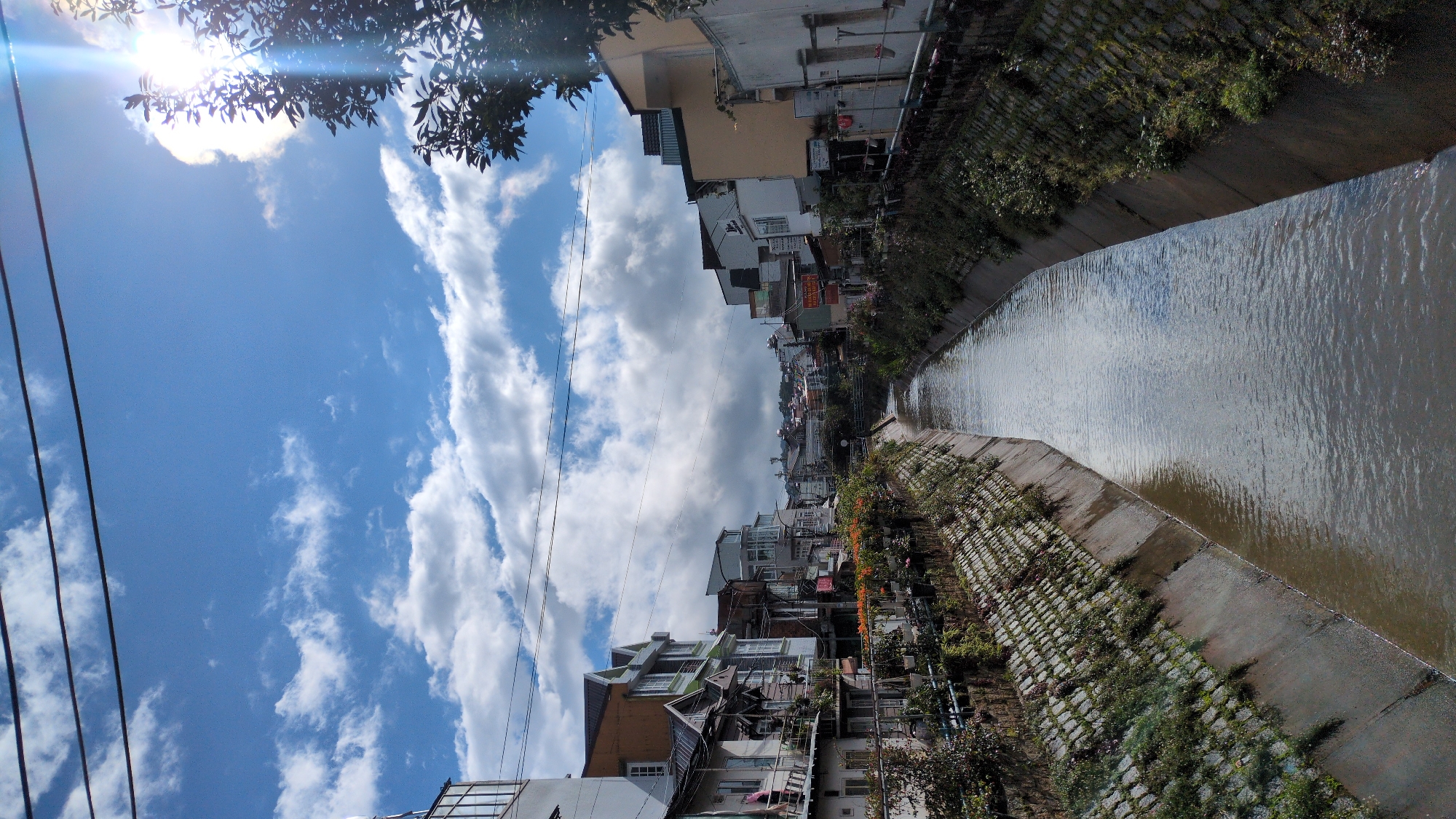Murky canal cuts through Da Lat's residential outskirts