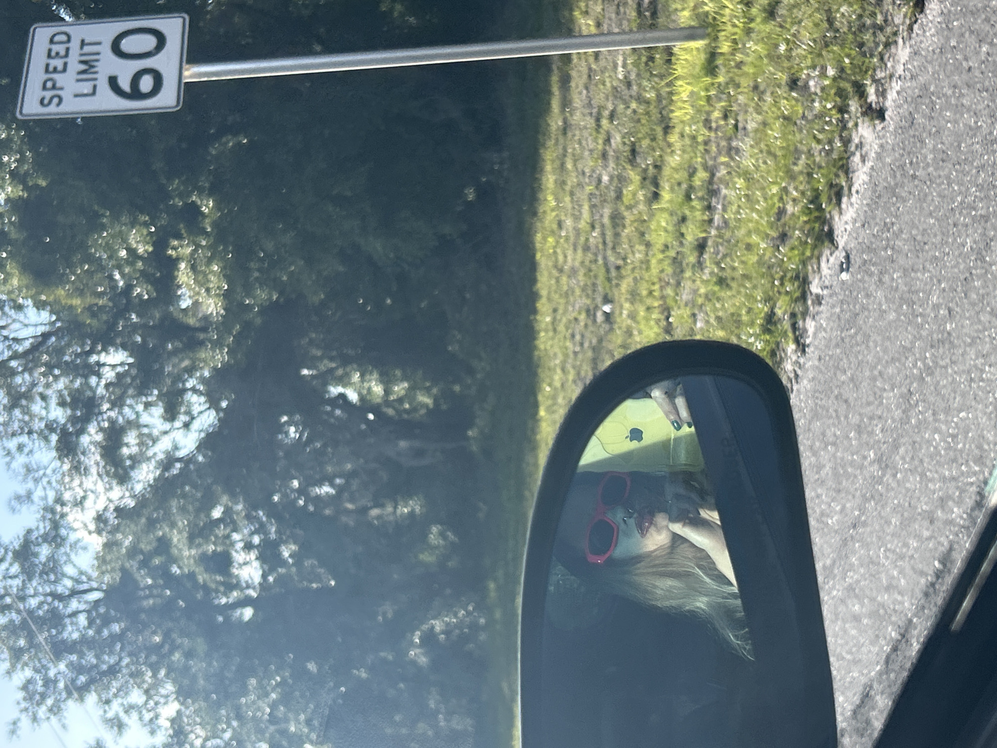 Driver spotted wearing red sunglasses in side mirror reflection