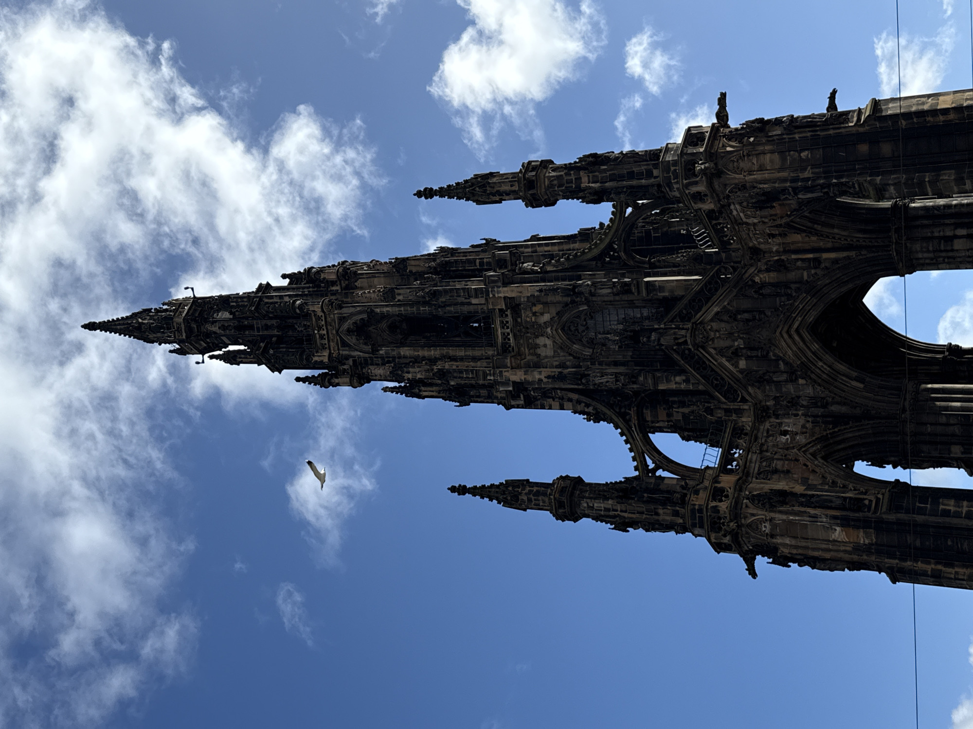 Tourist documents Edinburgh's Scott Monument from multiple angles