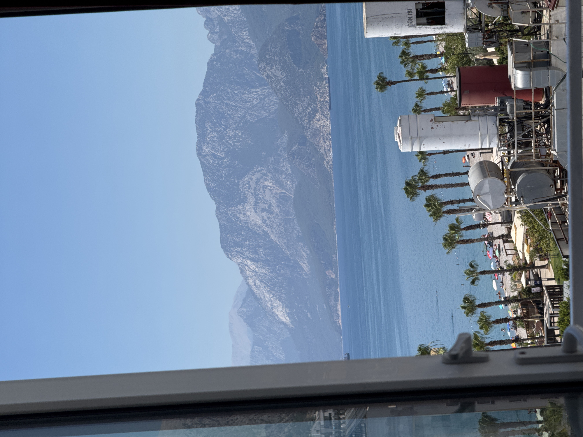 Konyaaltı's beach, hotels, and mountain backdrop on a summer morning