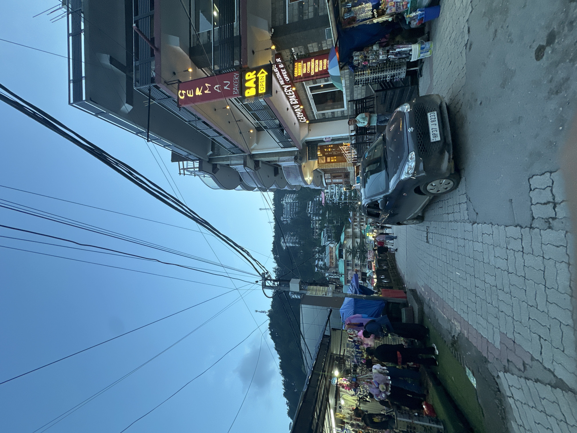 Busy hill town market streets, shops, and foot traffic