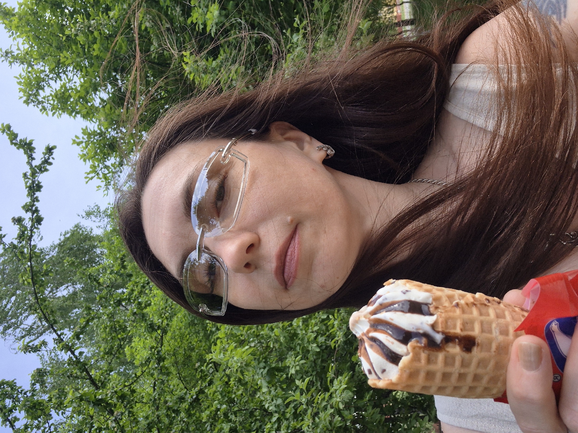 Park visitor captures ice cream, bench relaxation, fruit hashtag moments