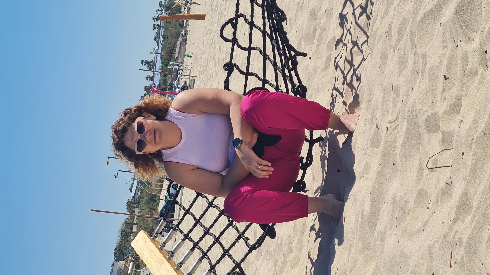 Woman relaxes on beach in Ashkelon under clear skies