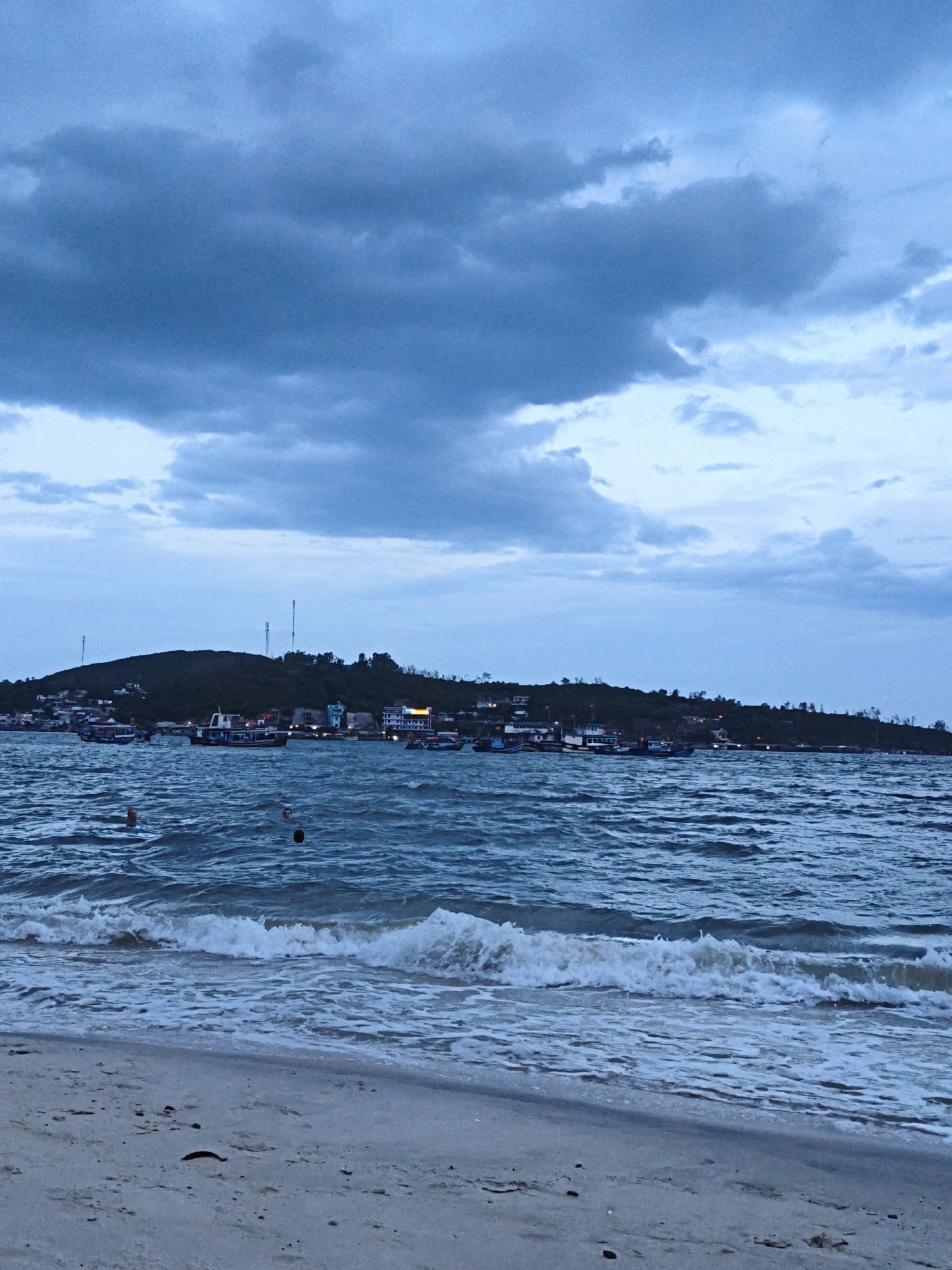Nha Trang beach at dusk, moody skies and rolling surf