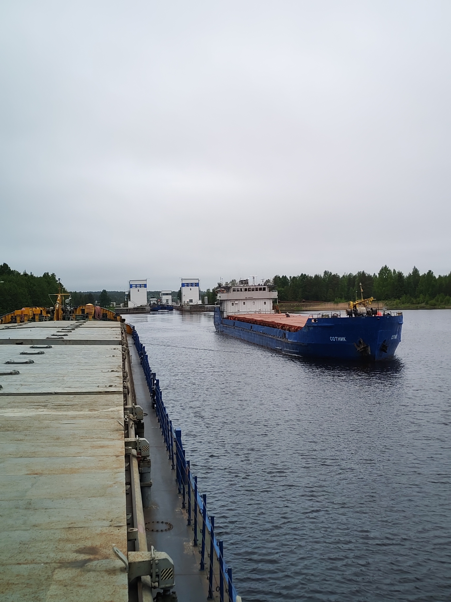Cargo barge Sotnik transits lock system in Devyatiny, Russia