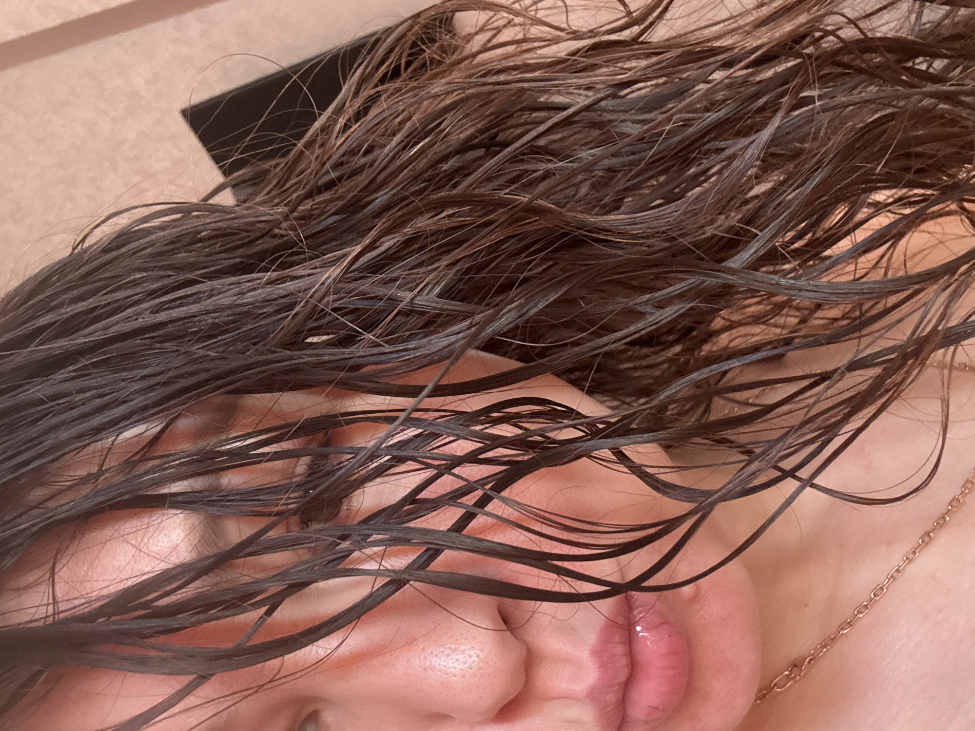 Person photographed with wet disheveled hair in Oktyabrskiy