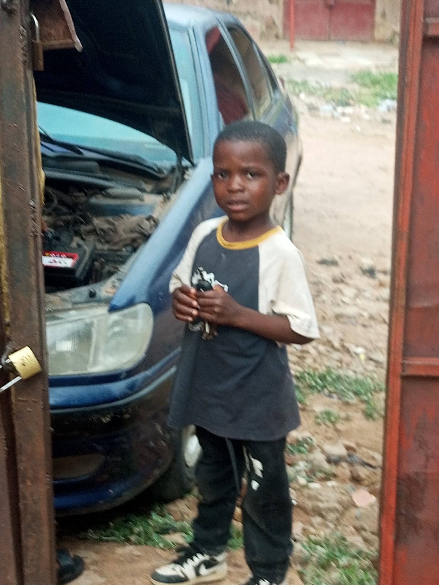 Blue car with hood open in Pantame, Nigeria