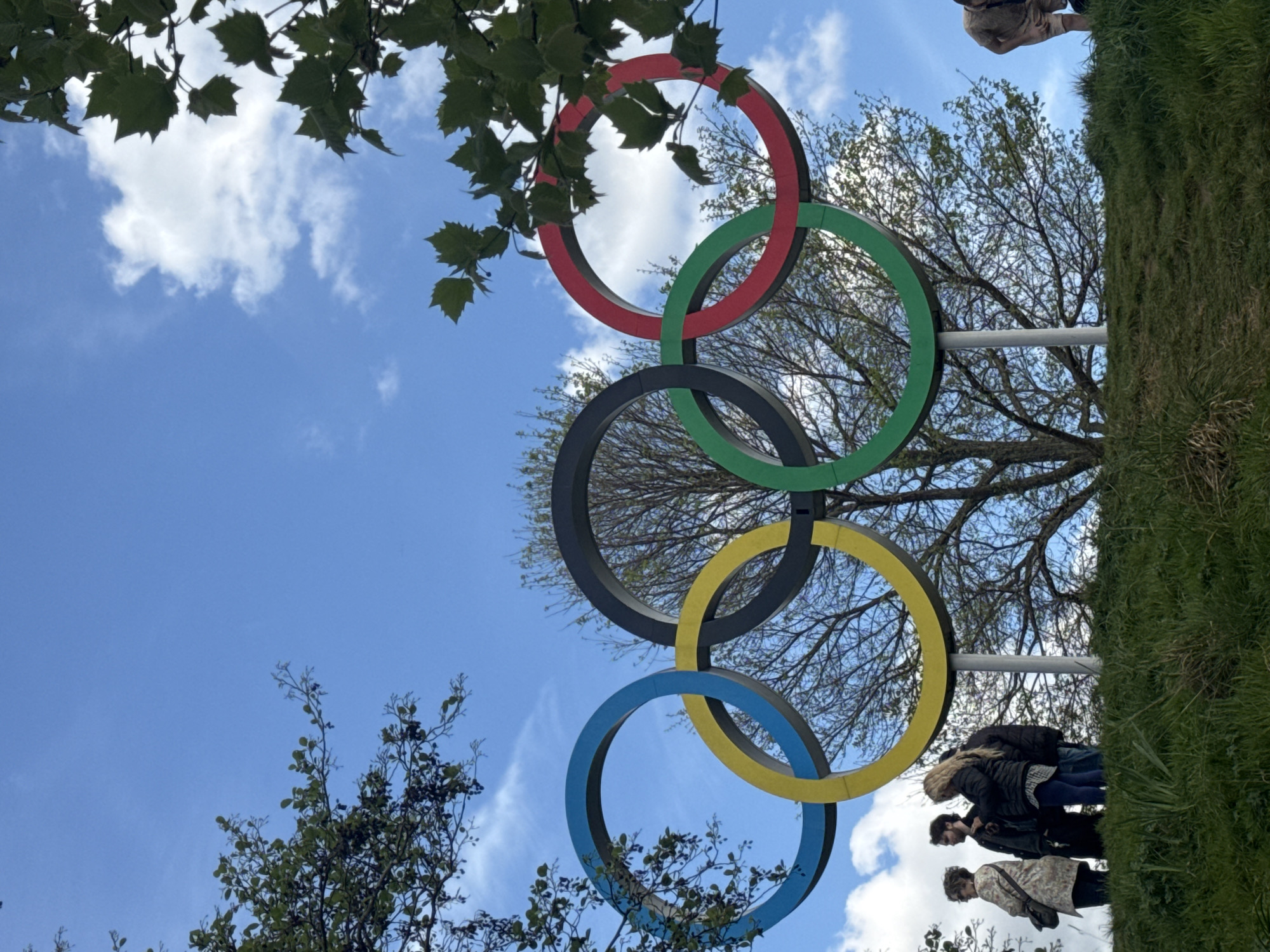 Visitor documents Olympic Park landmarks under afternoon London skies