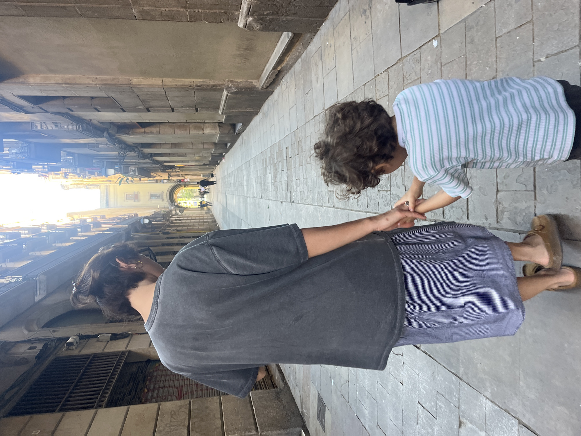 Adult and child walk through Gothic Quarter during renovation