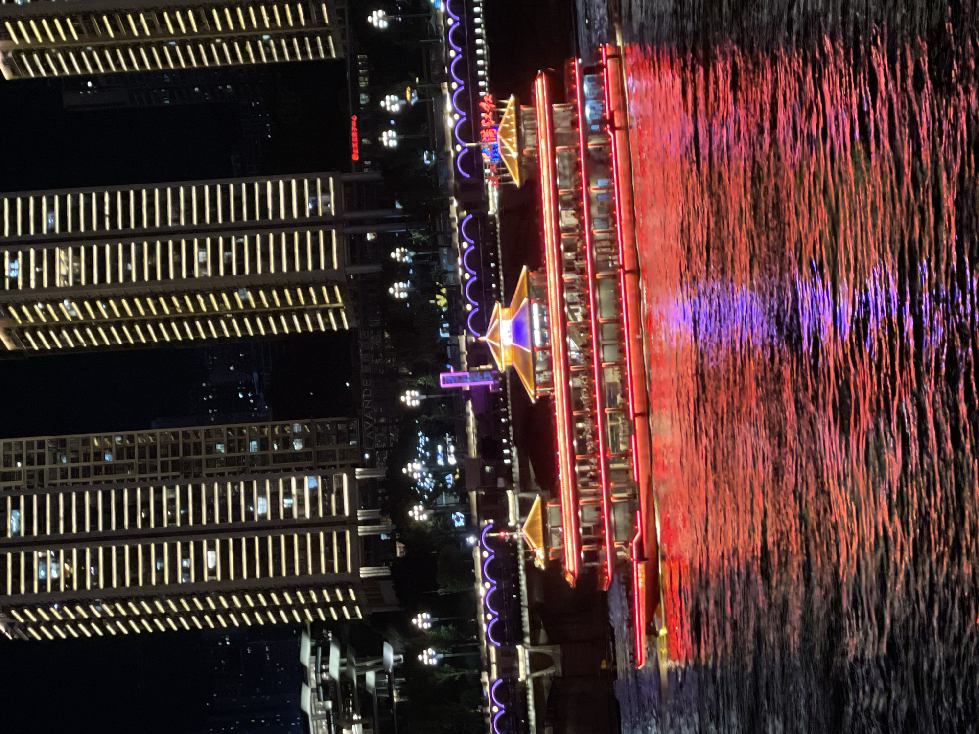 Chongqing's Yangtze riverfront alive with light and boats at night
