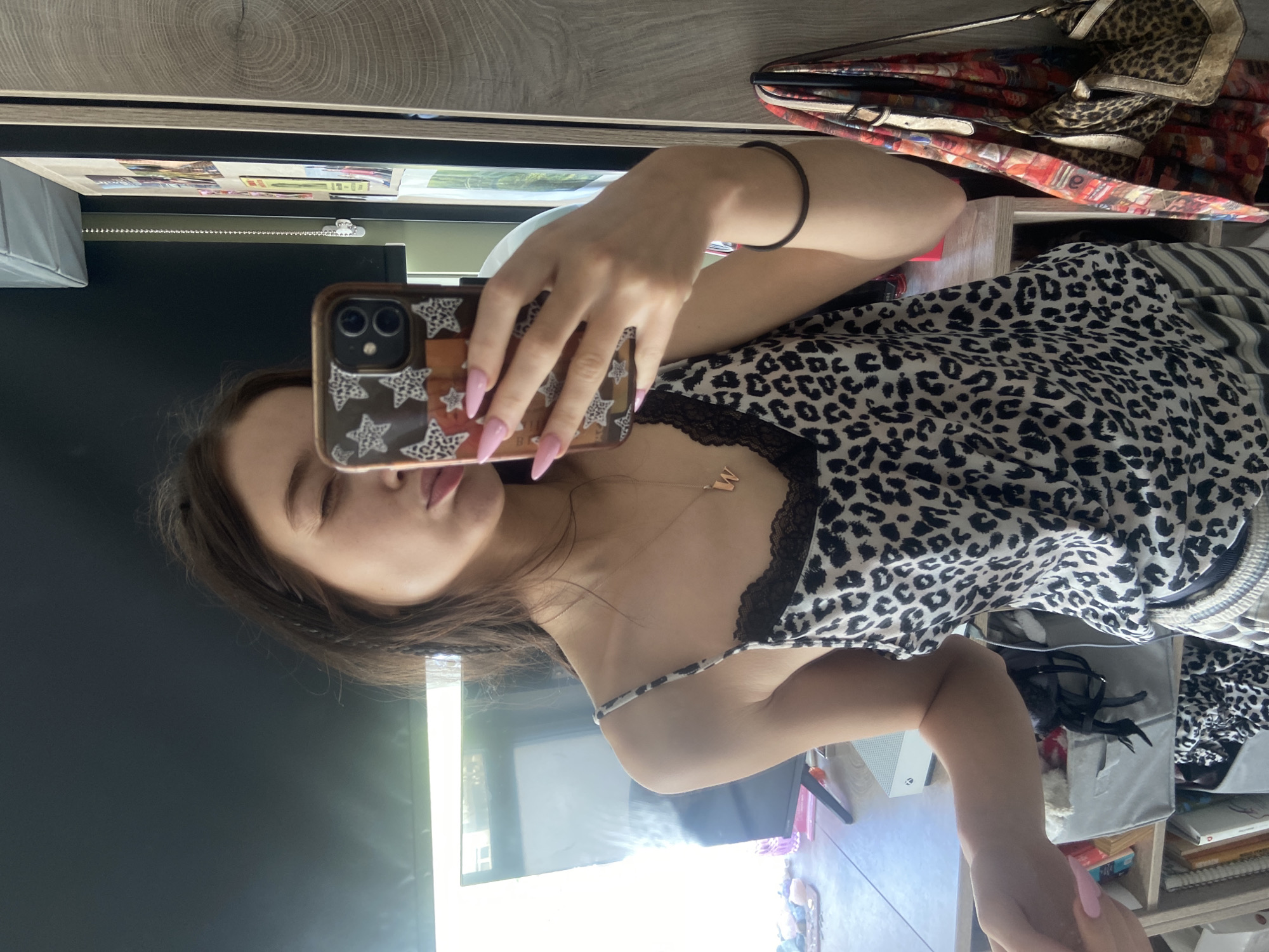 Woman takes bedroom selfie in leopard print top, London