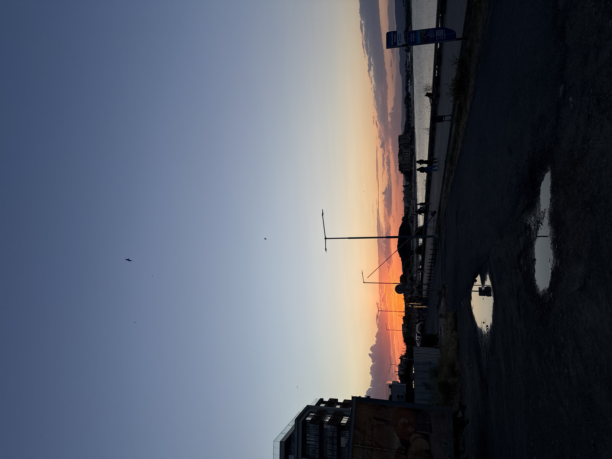 Nesebar promenade at golden hour with tourist trains rolling by