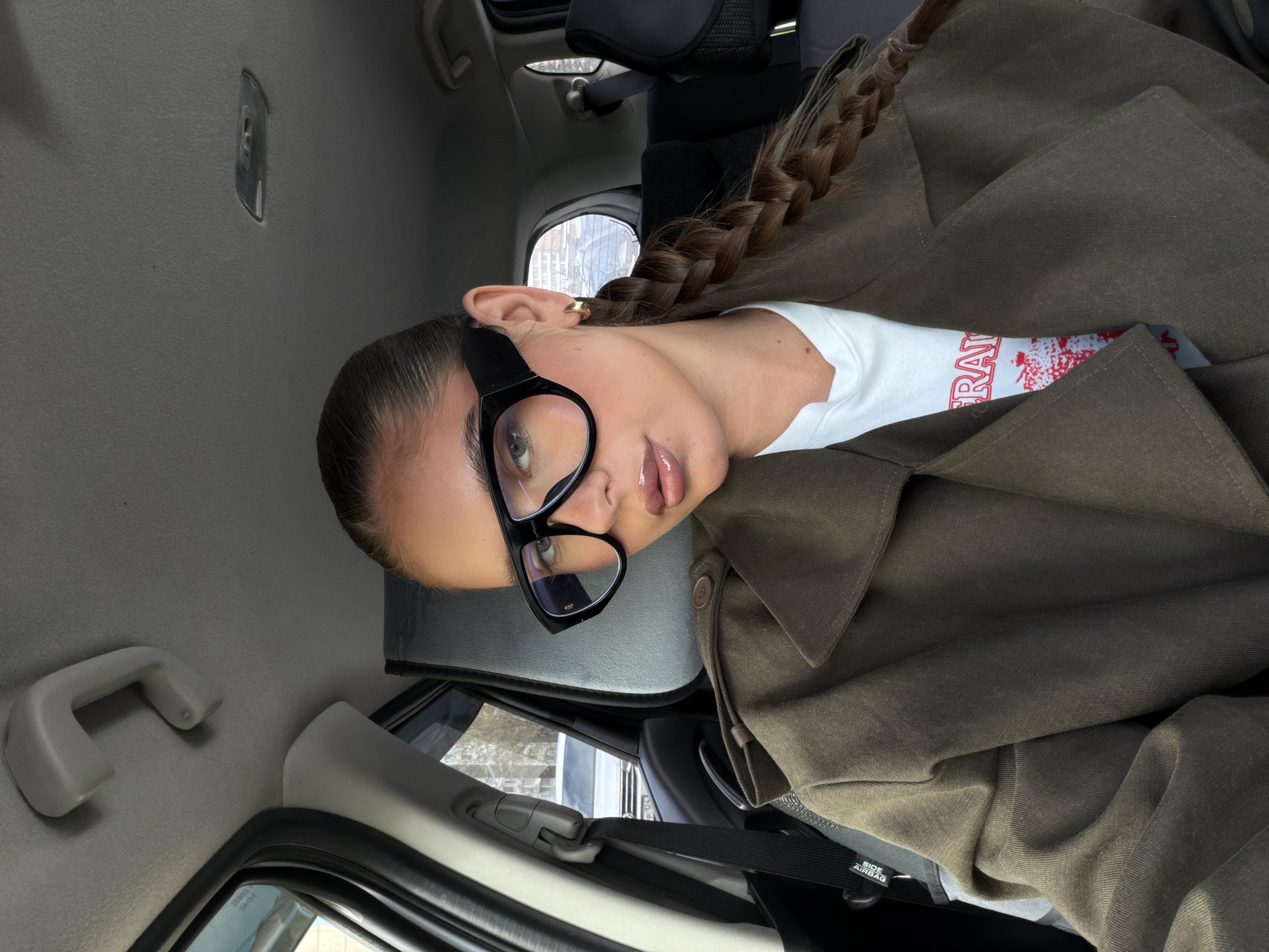 Woman in braids observed in car passenger seat, Krasnoyarsk