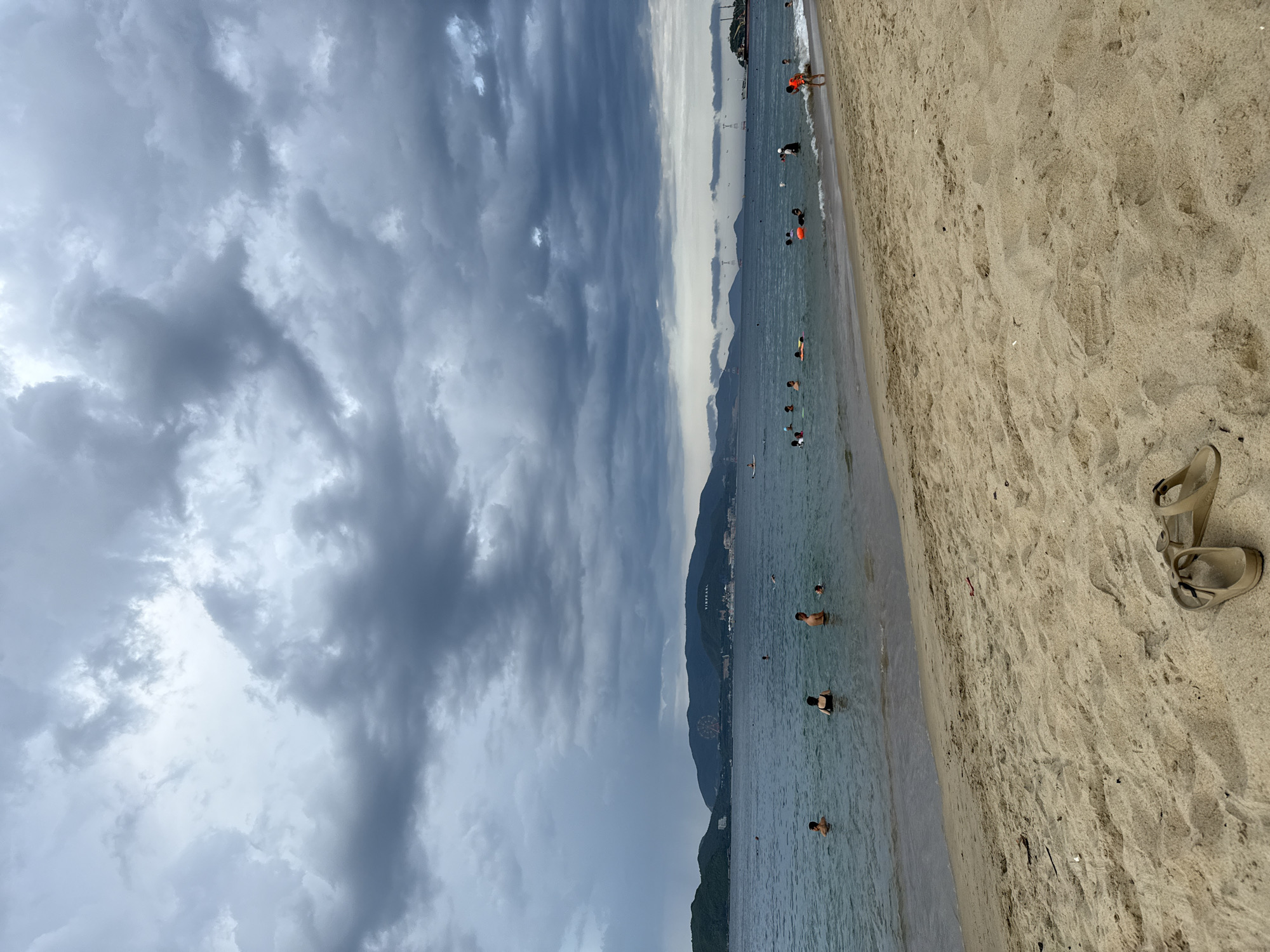 Overcast morning at Nha Trang beach — sand, surf, and volleyball